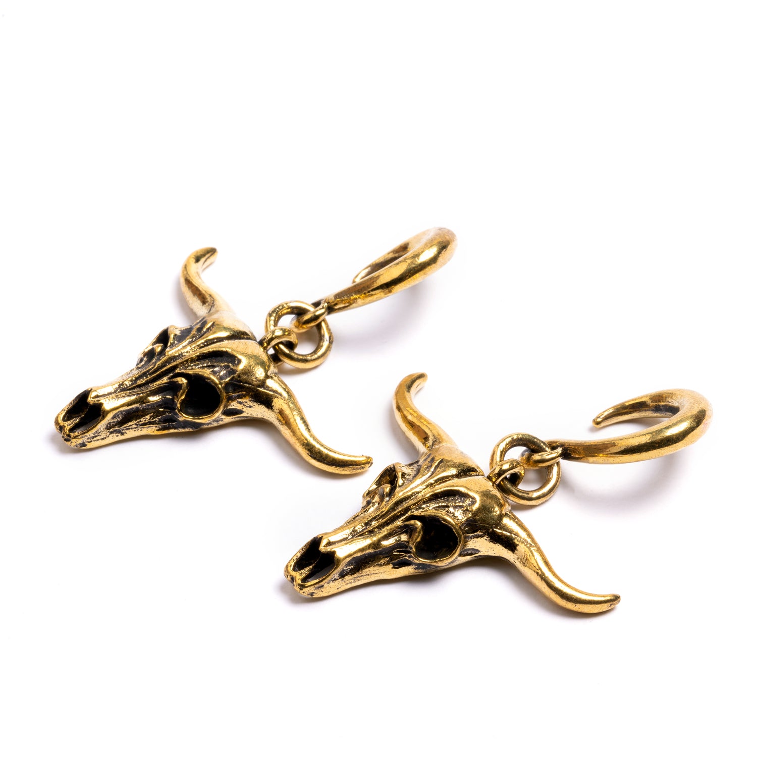 pair of gold brass longhorn skull ear weights hangers side view