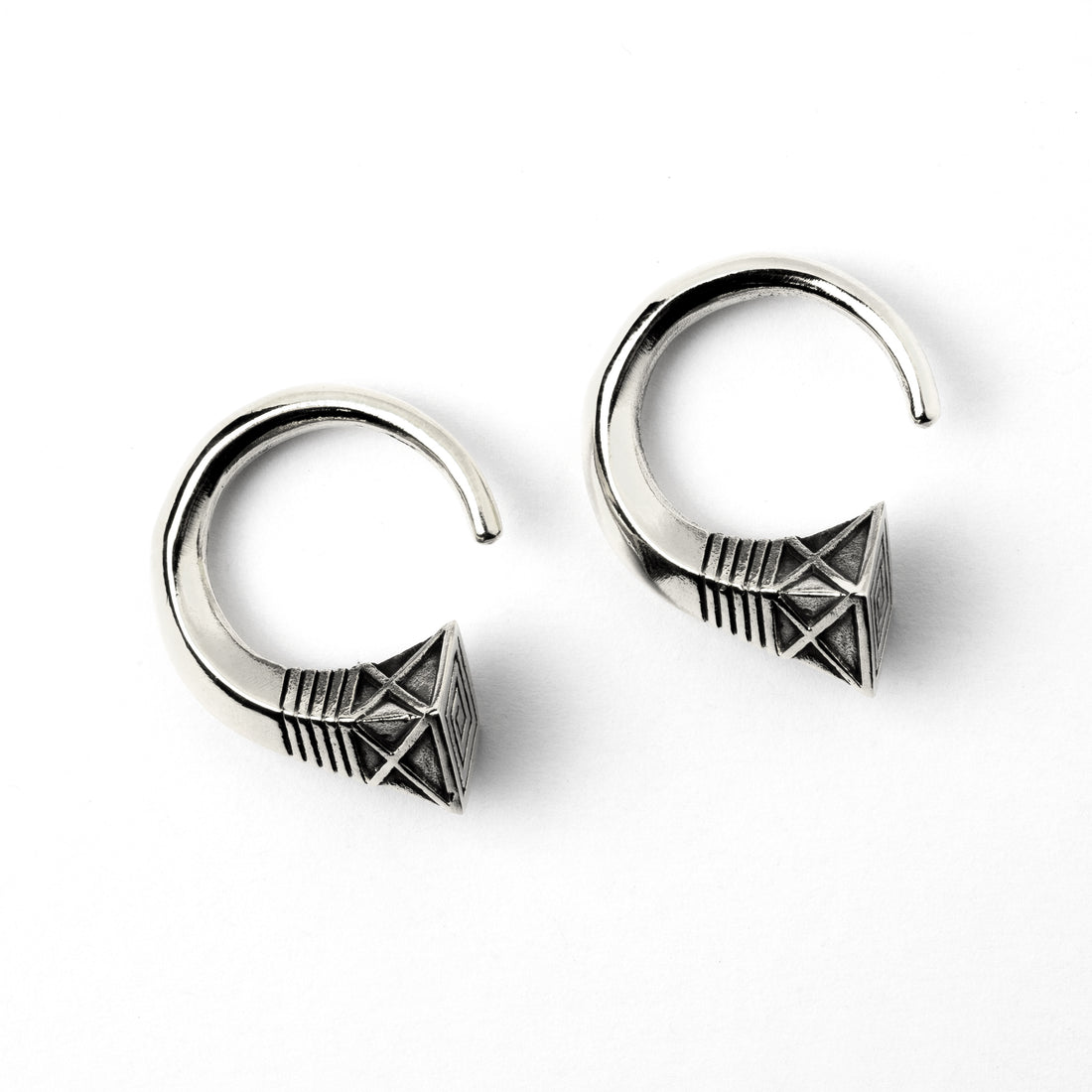 pair of white brass hook weights hangers with geometric design frontal view