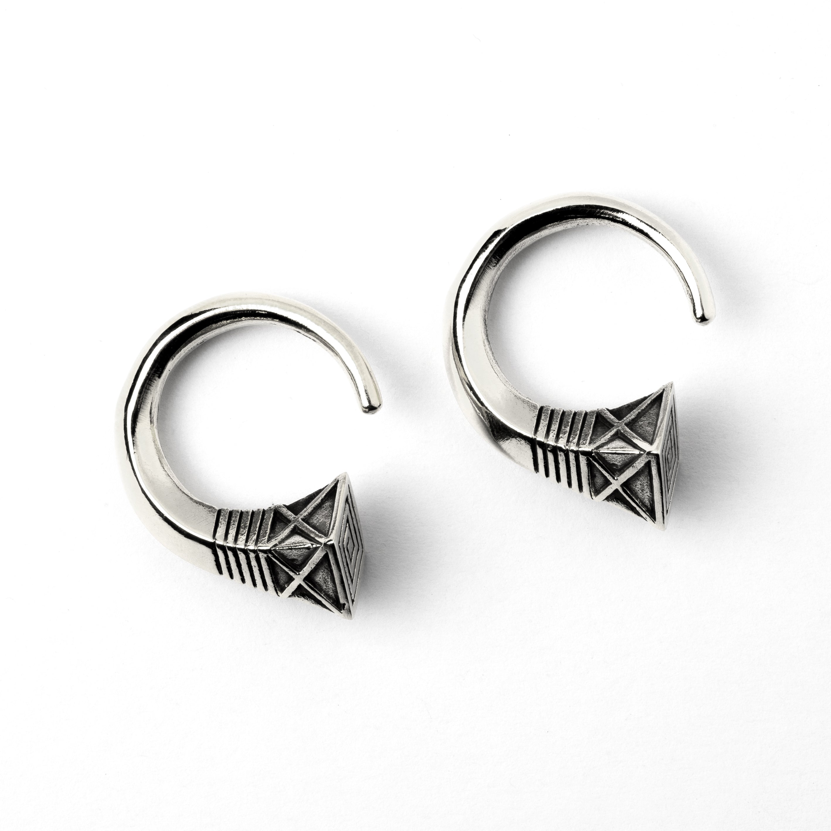 pair of white brass hook weights hangers with geometric design frontal view