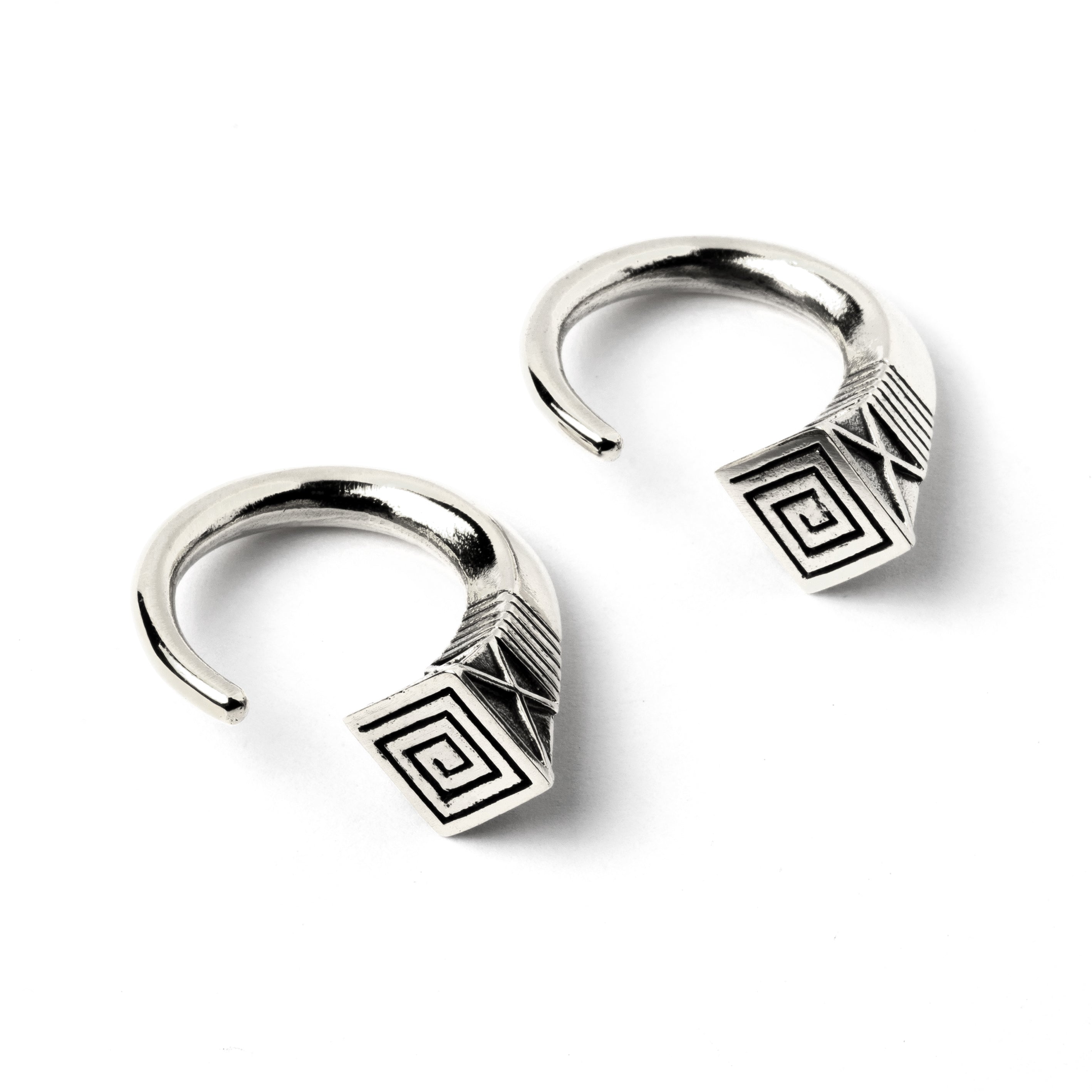 pair of white brass hook weights hangers with geometric design side view