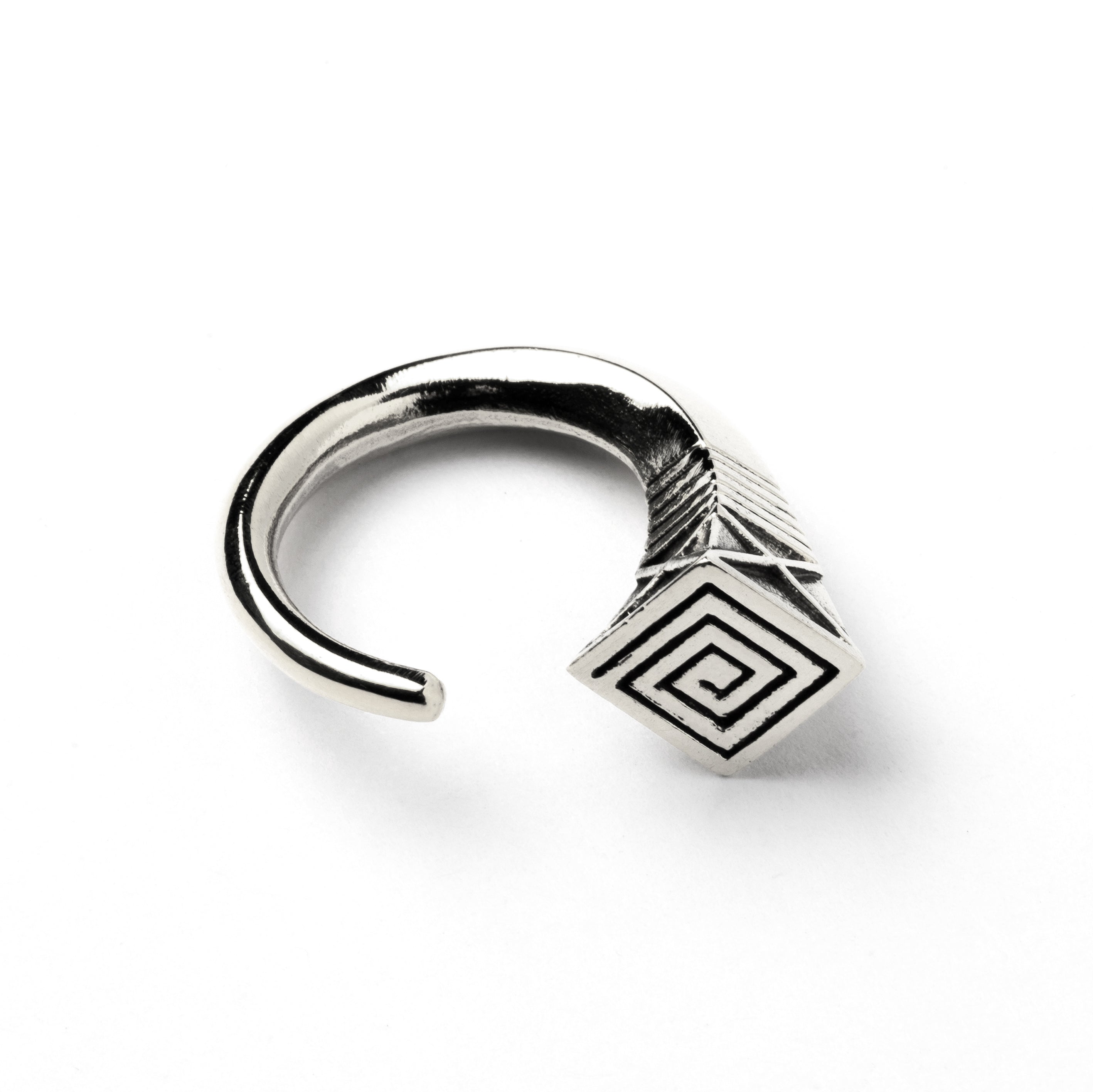 single white brass hook weight hanger with geometric design side close up view
