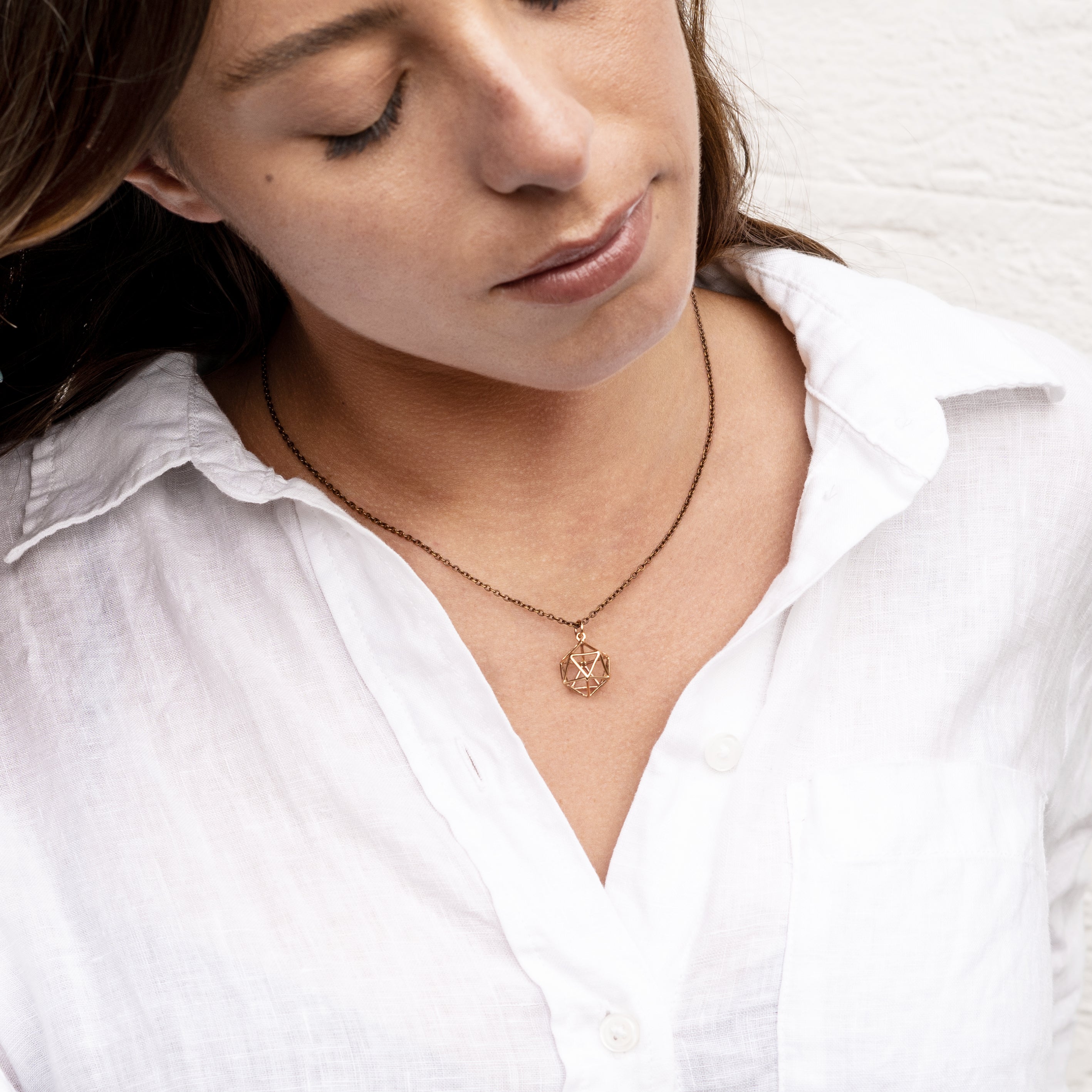 model wearing Bronze Icosahedron pendant necklace