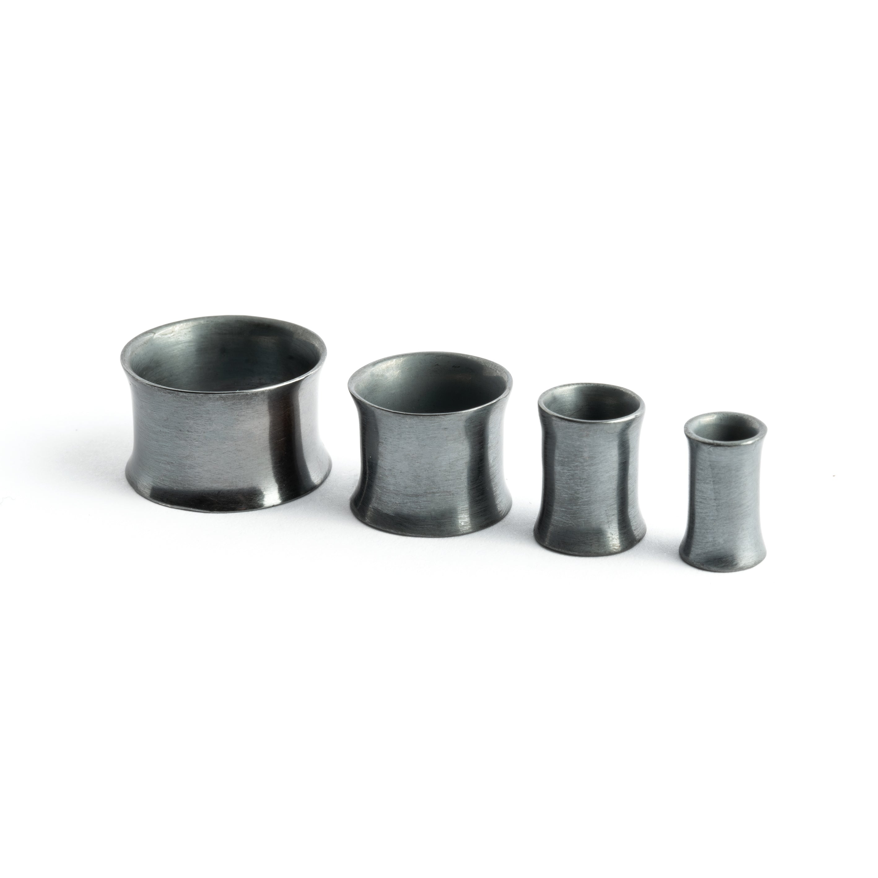 different sizes of plain minimalistic black Silver ear tunnels side view