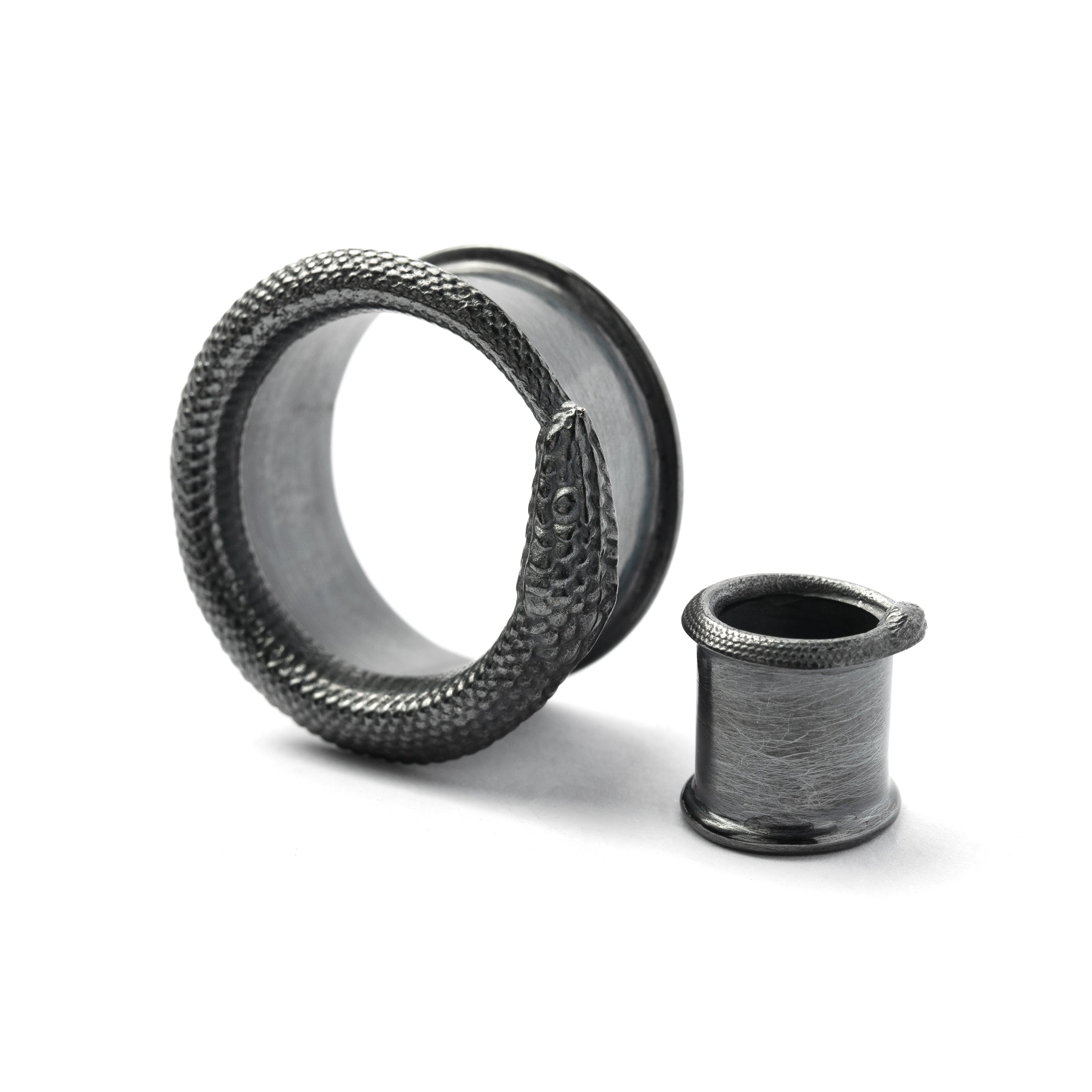 two sizes Ouroboros black silver ear tunnels side view