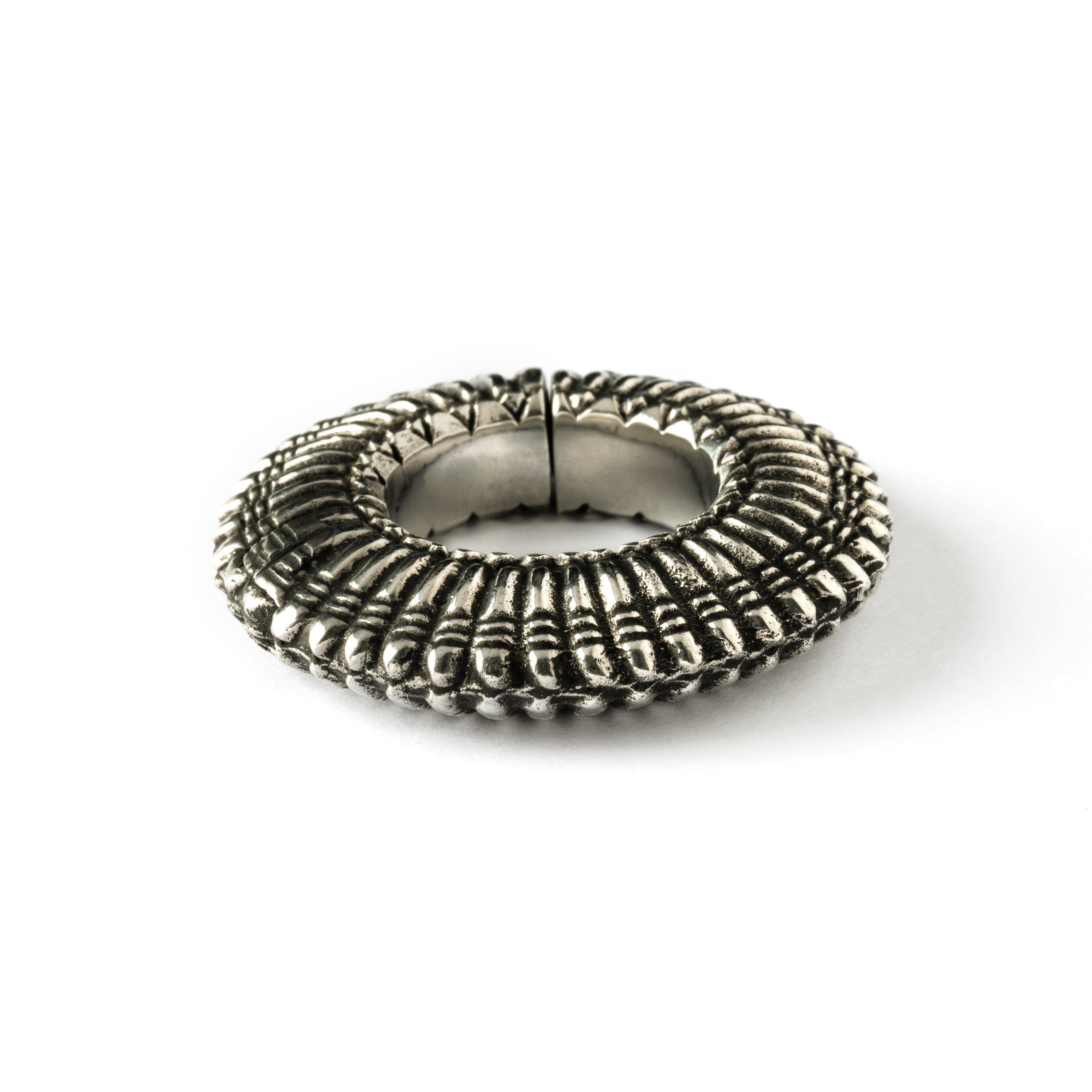 Silver colour ear weight hoop with carved lines close up side view