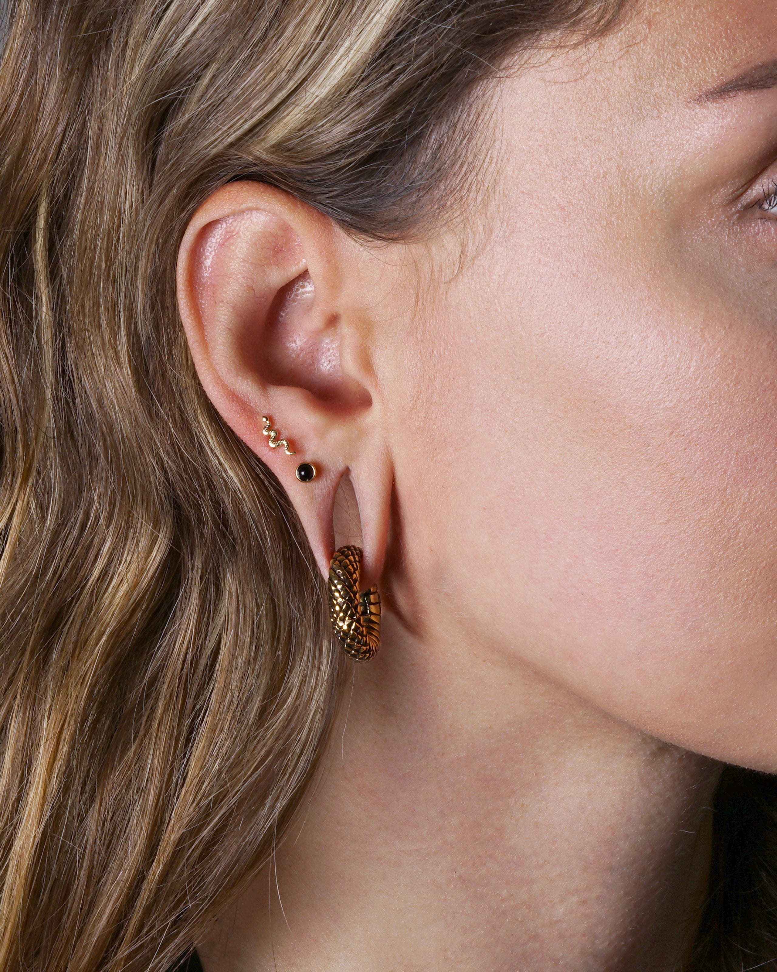 model wearing Rebirth brass Weight Hoops