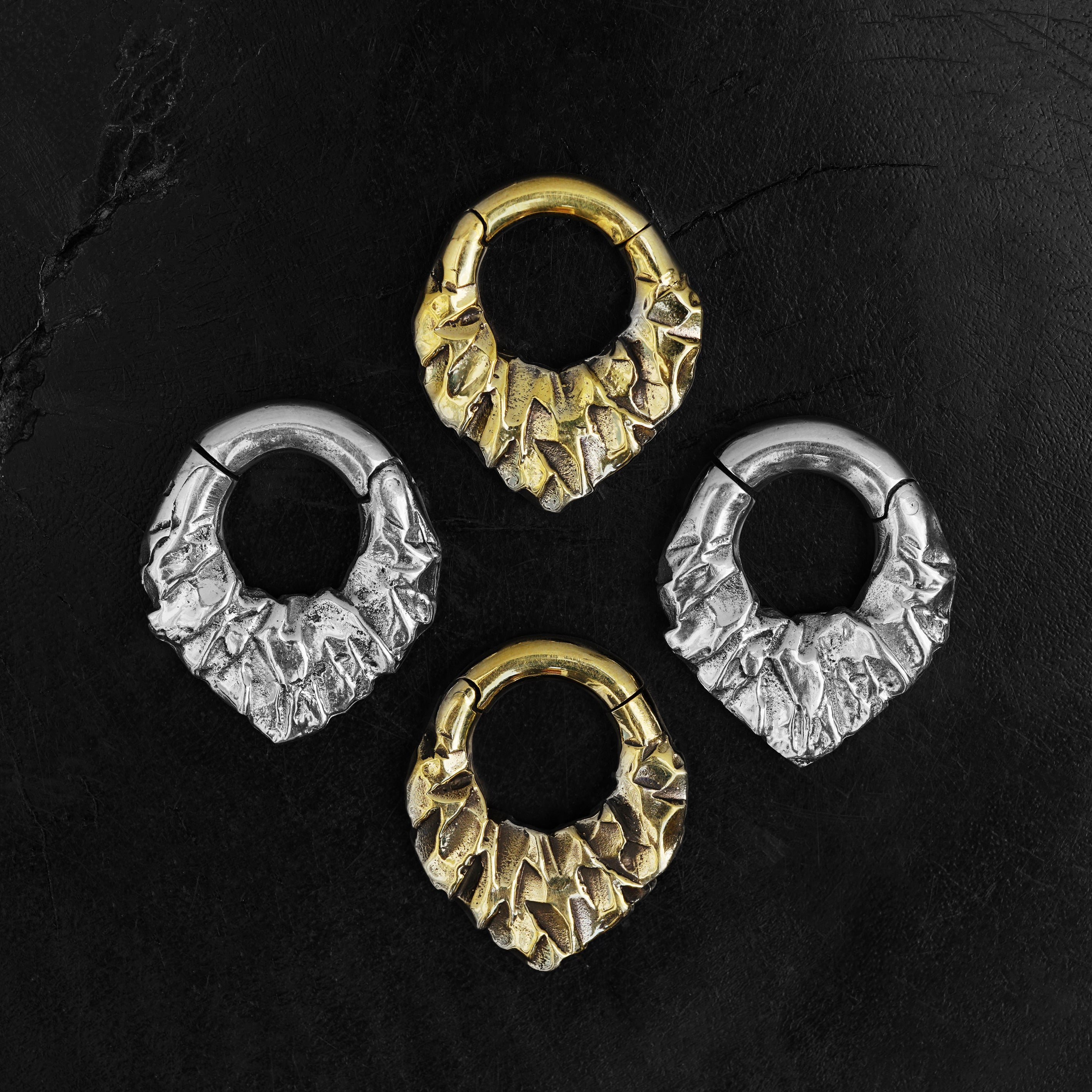 pairs of gold and silver brass teardrop shaped ear hoops hangers with rocky texture frontal view