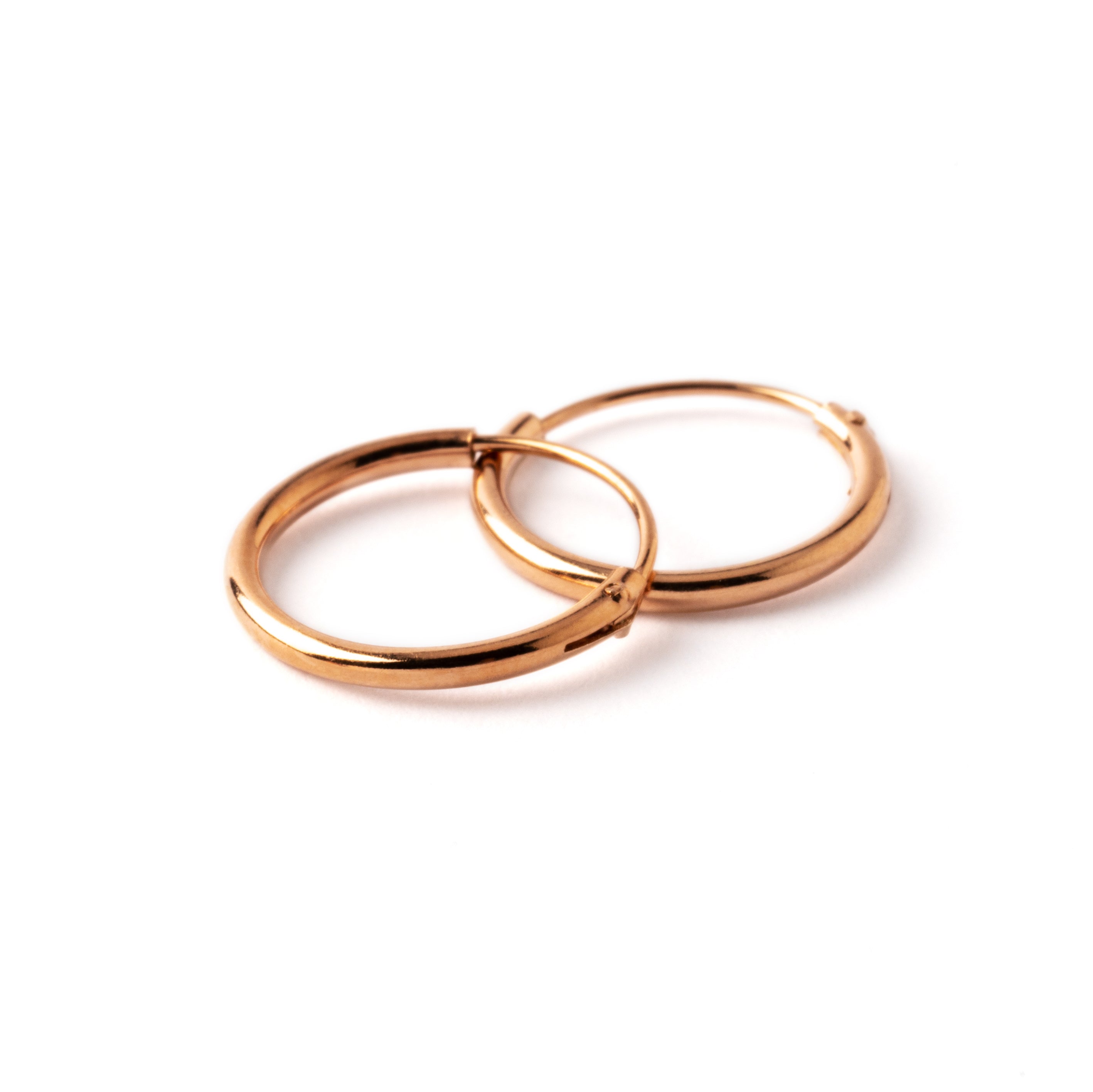 pair of rose gold hoop earrings side view