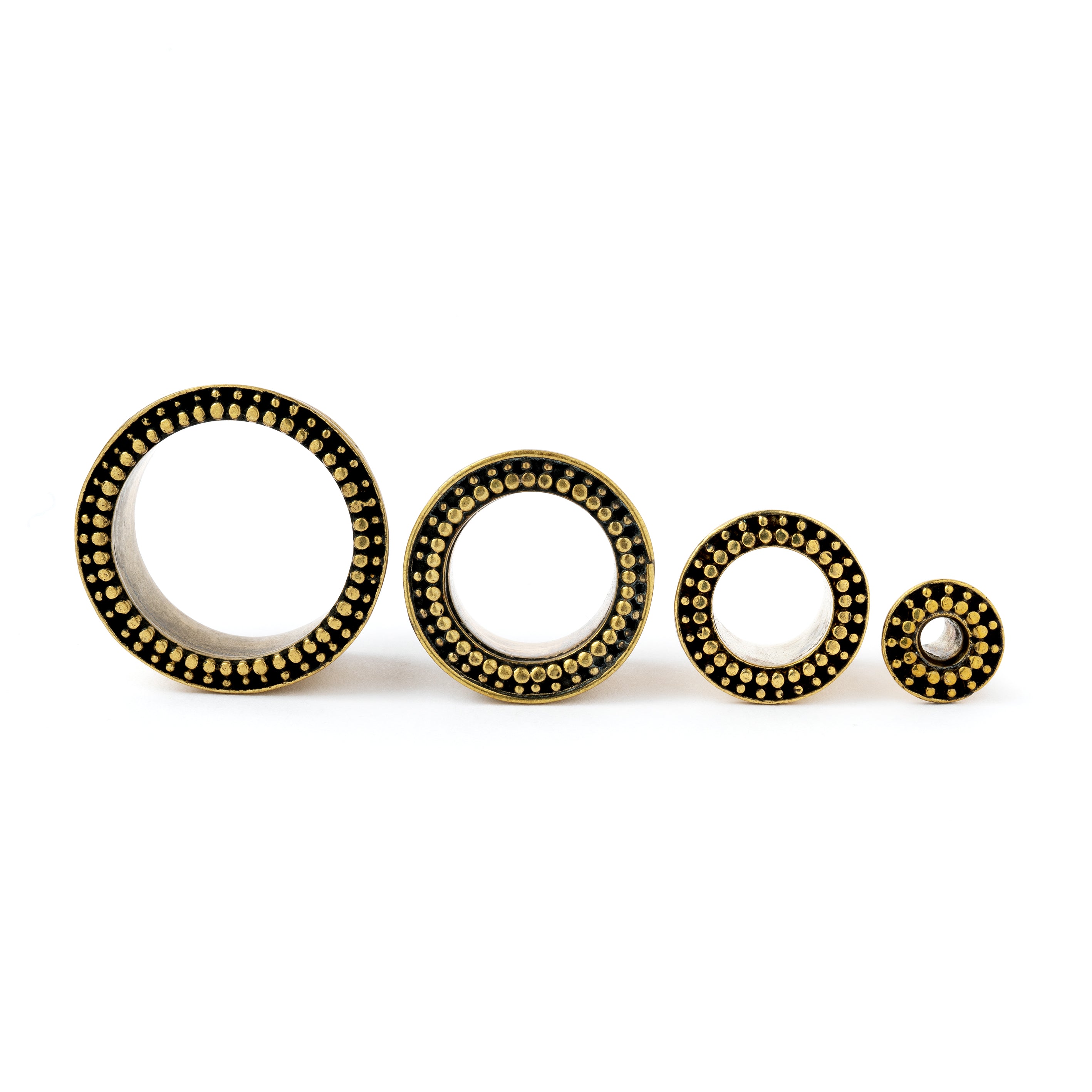 several sizes golden brass orbit ear tunnels front view