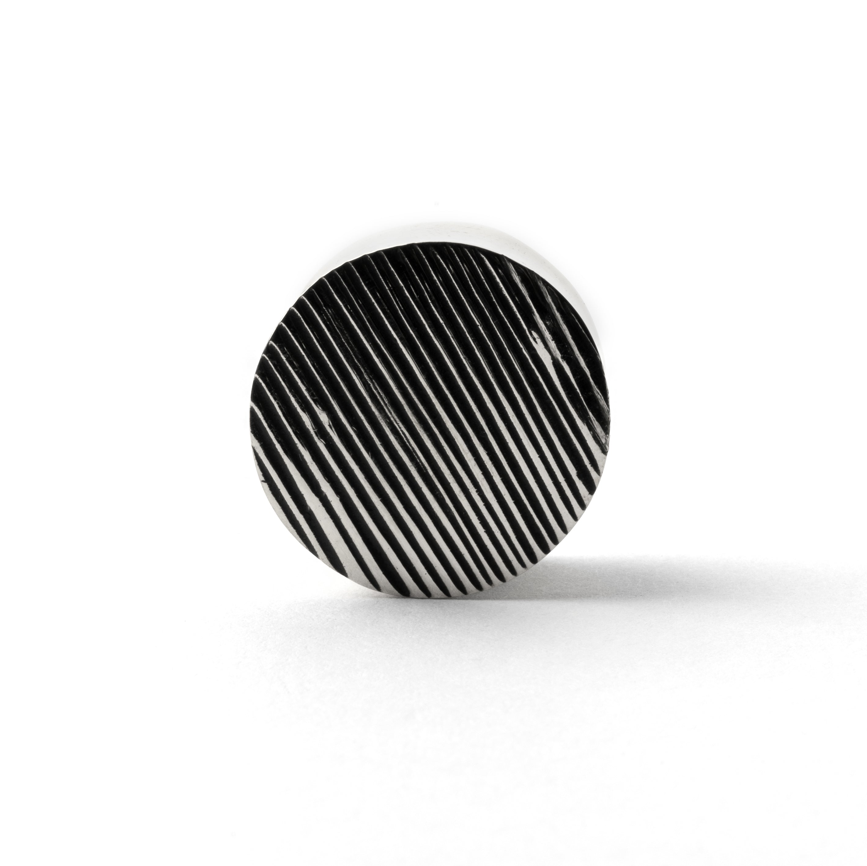 single scratched double flared ear plug frontal view