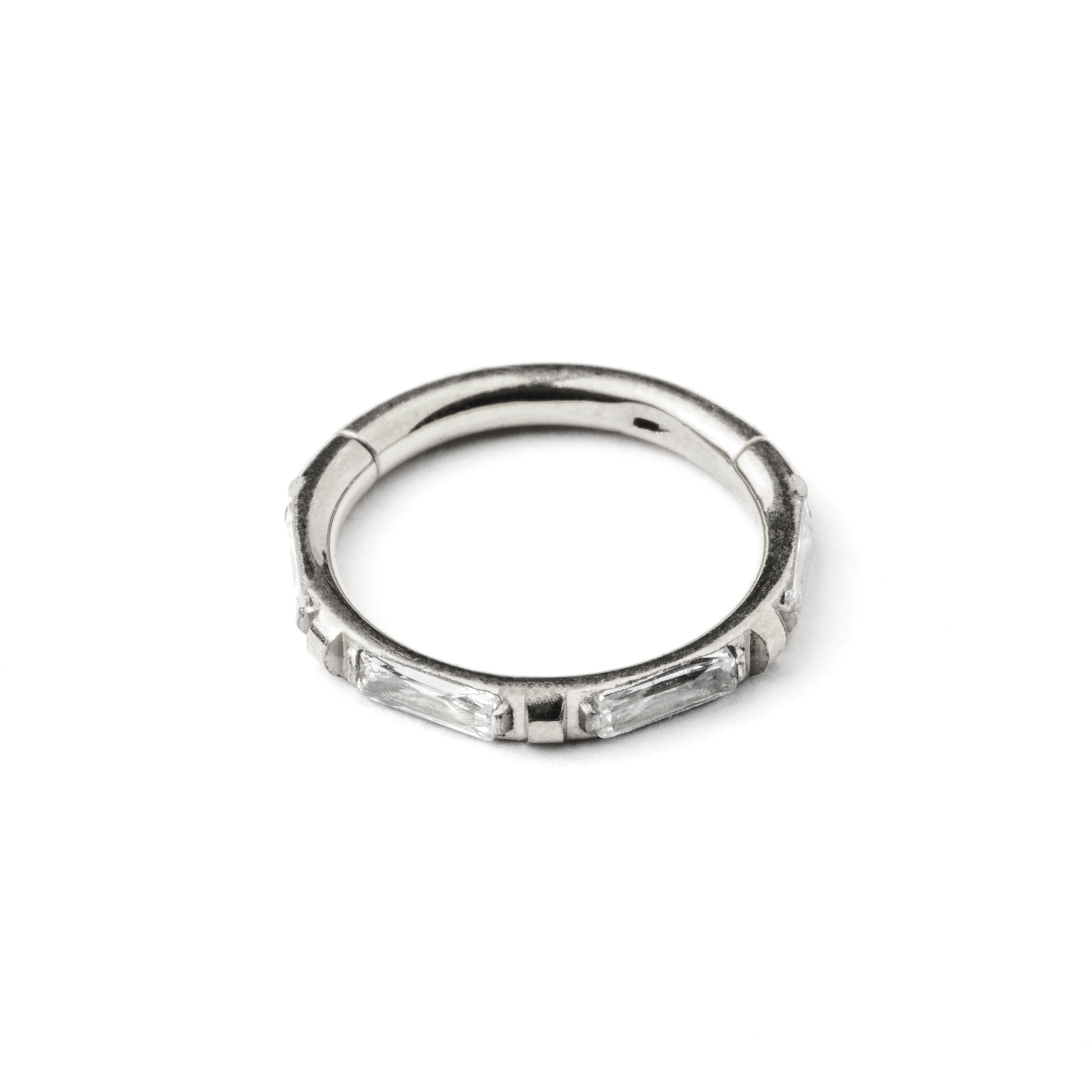 surgical steel septum clicker with crystal quartz around its rim frontal view