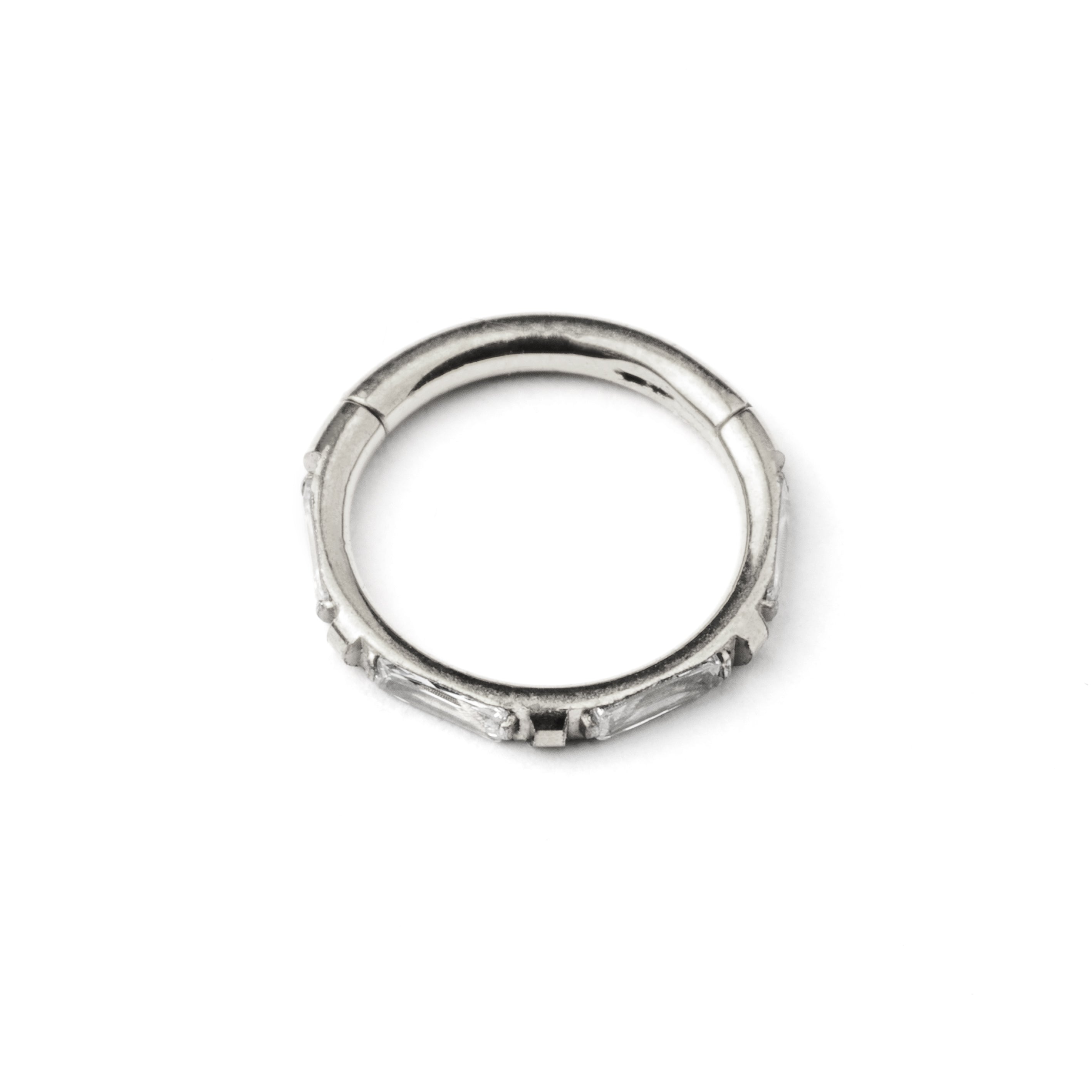 surgical steel septum clicker with crystal quartz around its rim frontal view