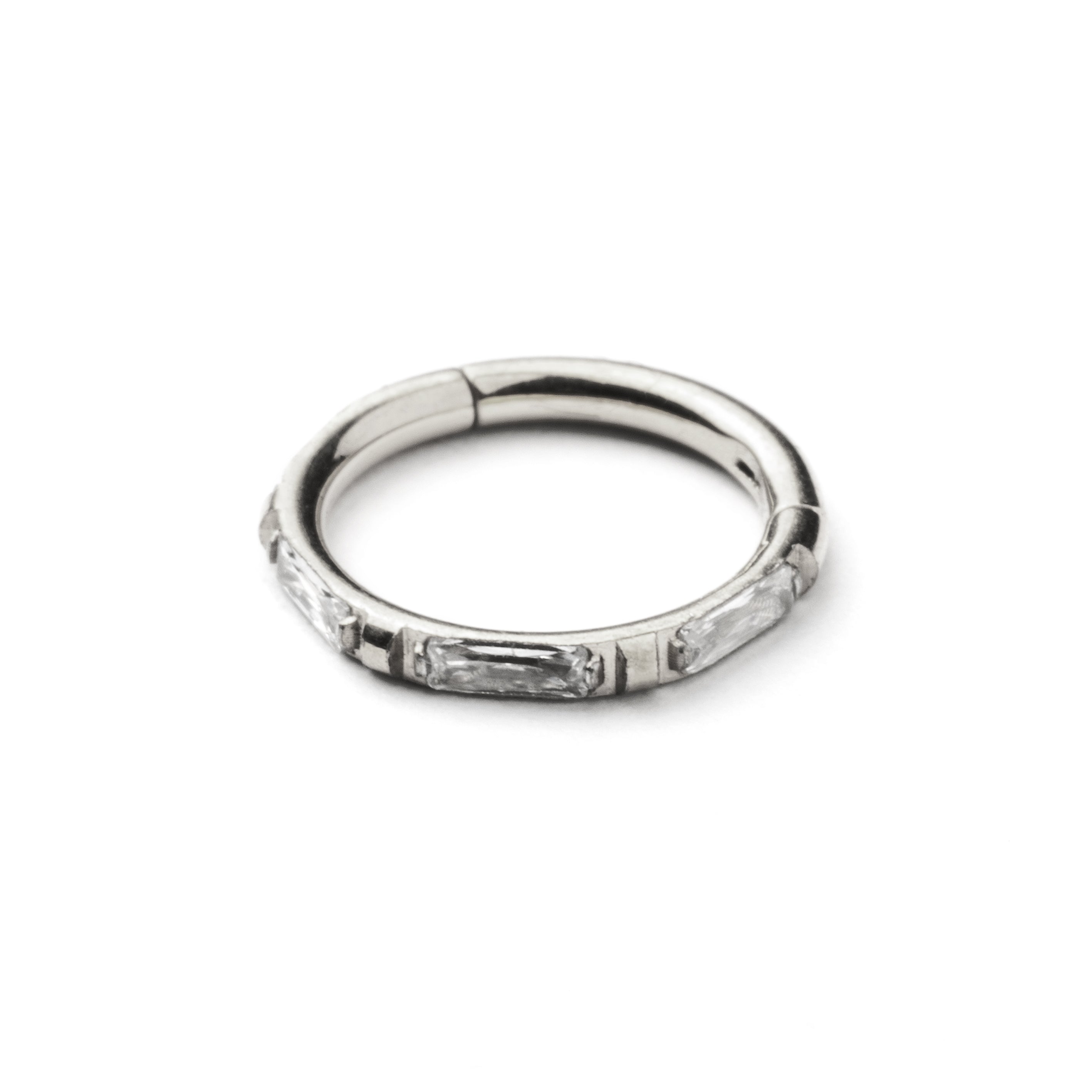 surgical steel septum clicker with crystal quartz around its rim frontal view