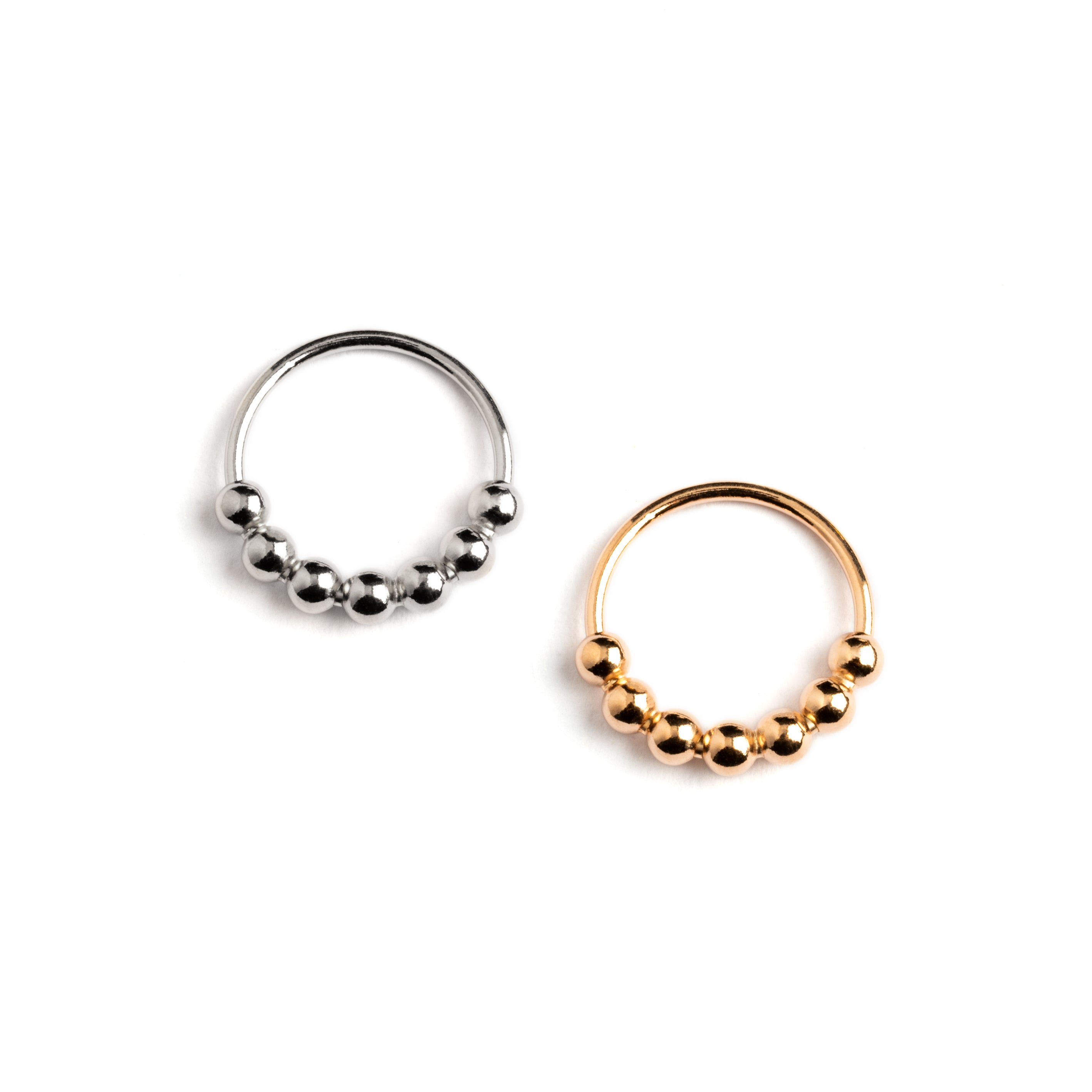 Silver and rose gold beaded nose rings frontal view