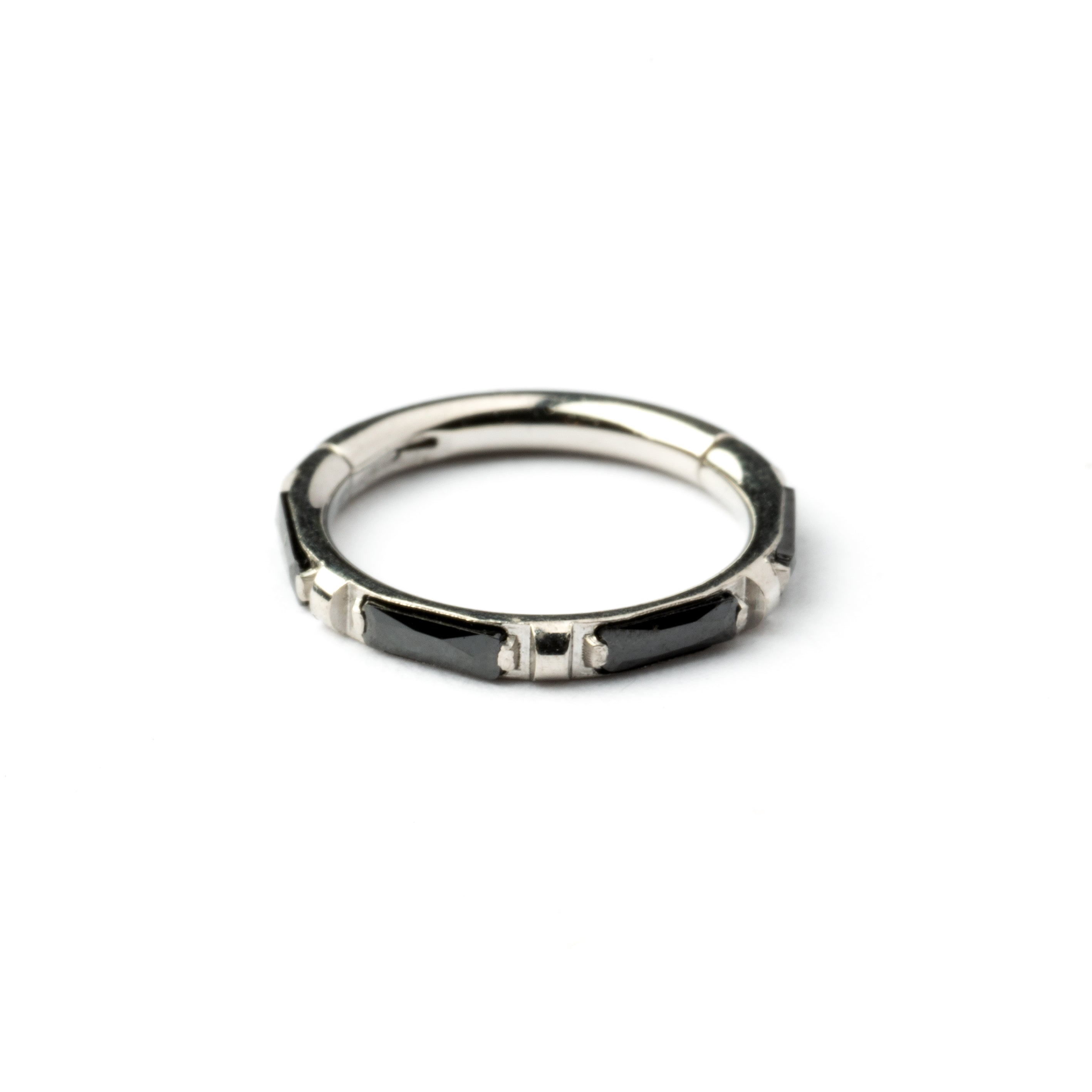 surgical steel septum clicker with black onyx stones around its rim frontal view