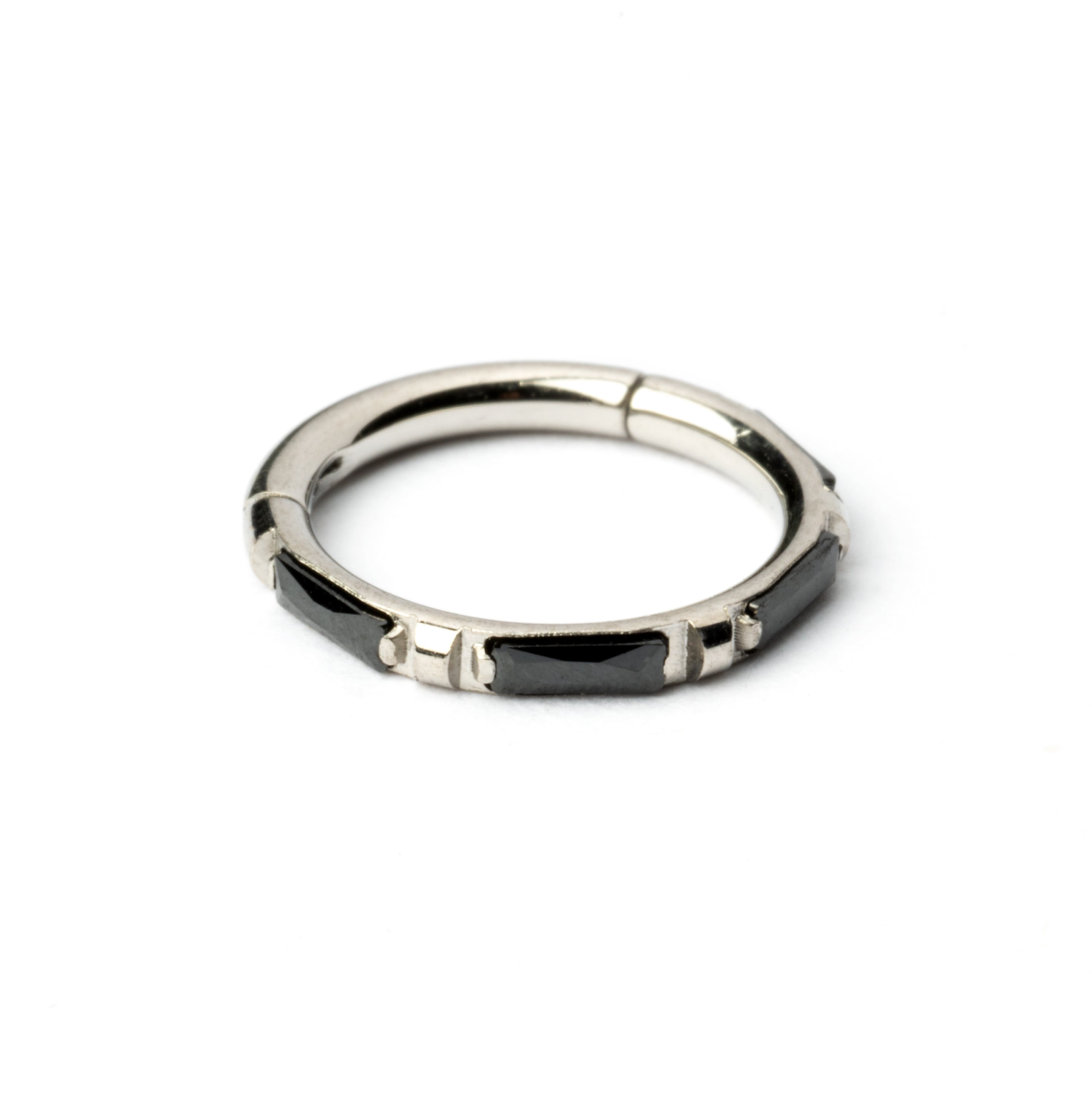surgical steel septum clicker with black onyx stones around its rim frontal view