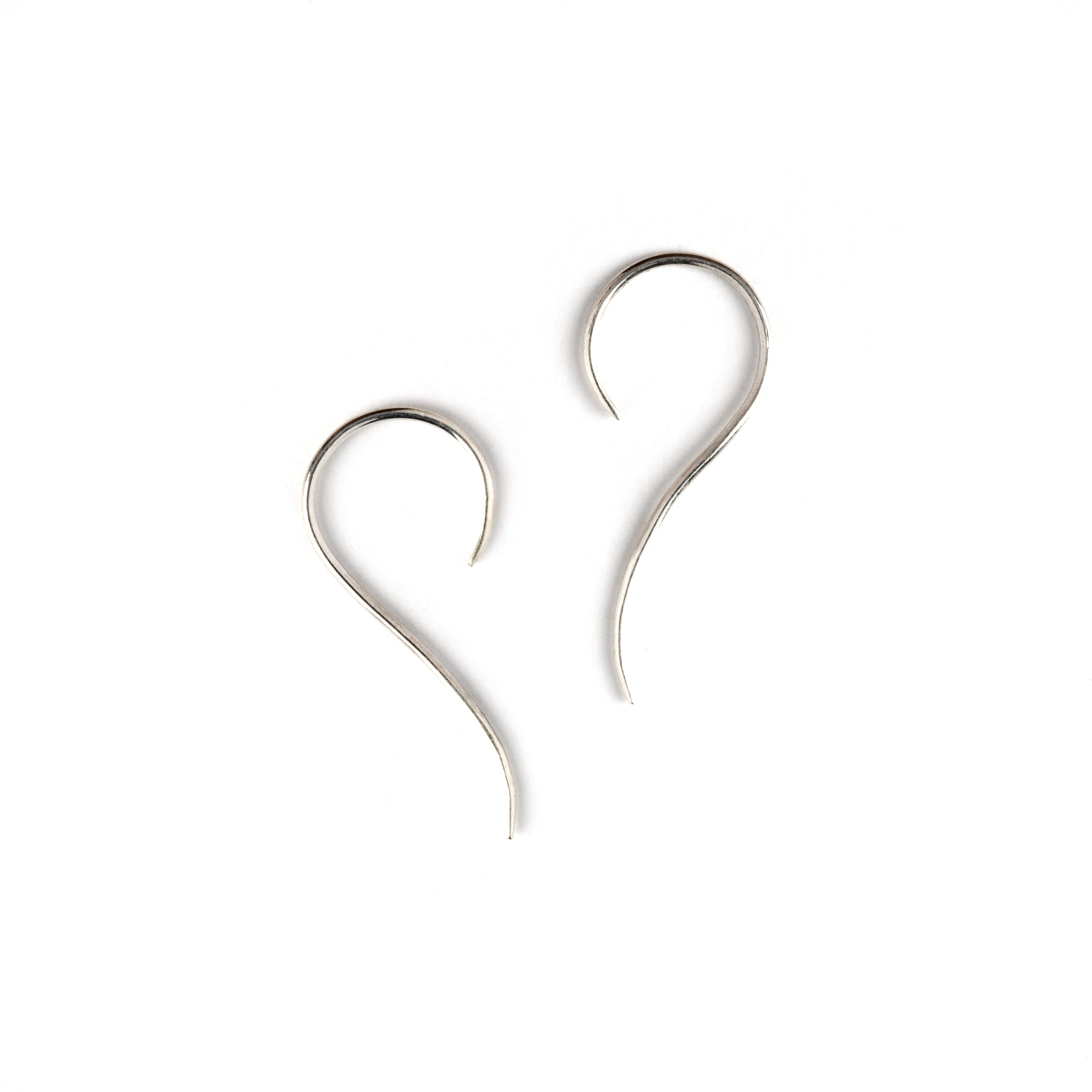 pair of silver wire hook earrings side view