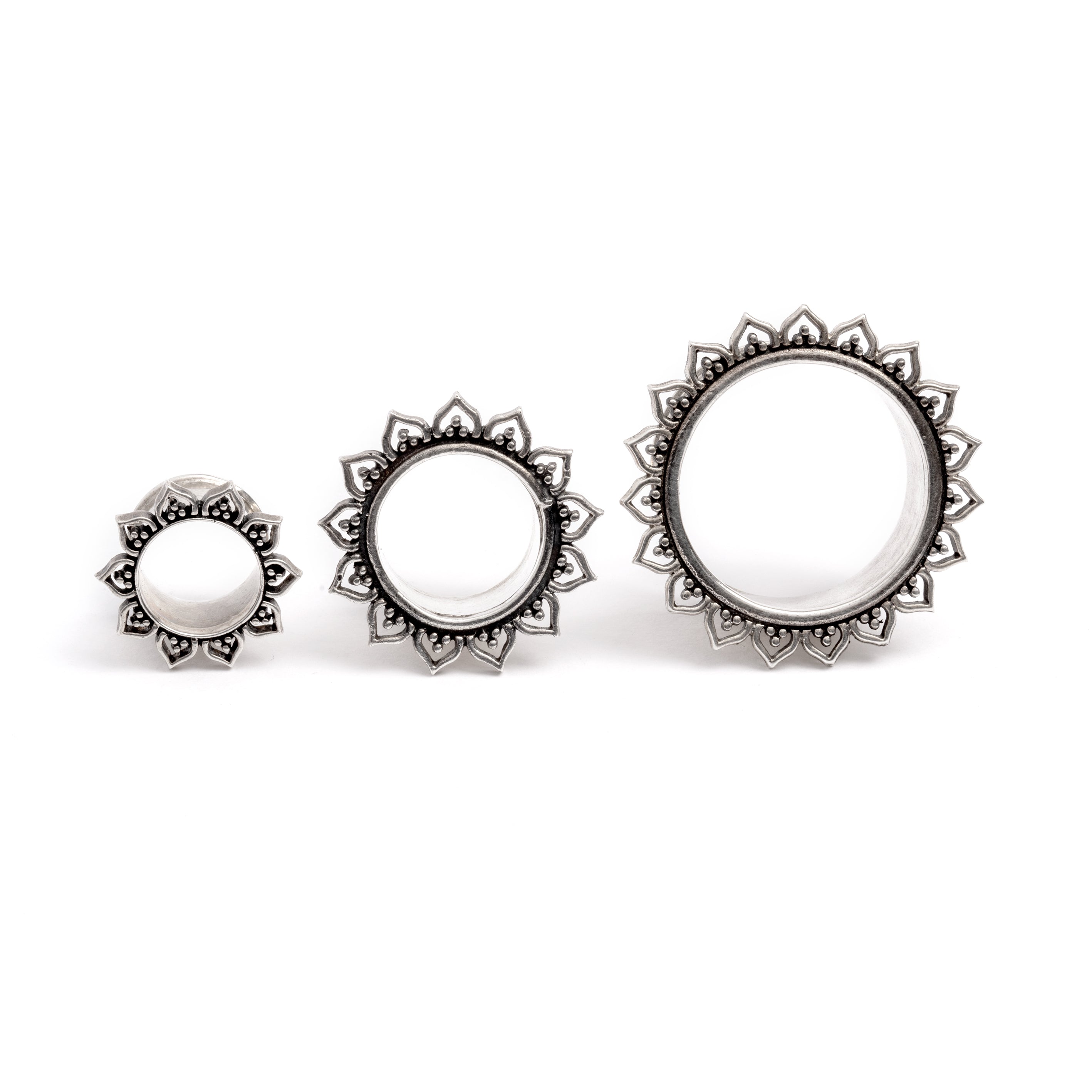 three sizes of Iriya Lotus Petals Silver ear tunnels frontal view
