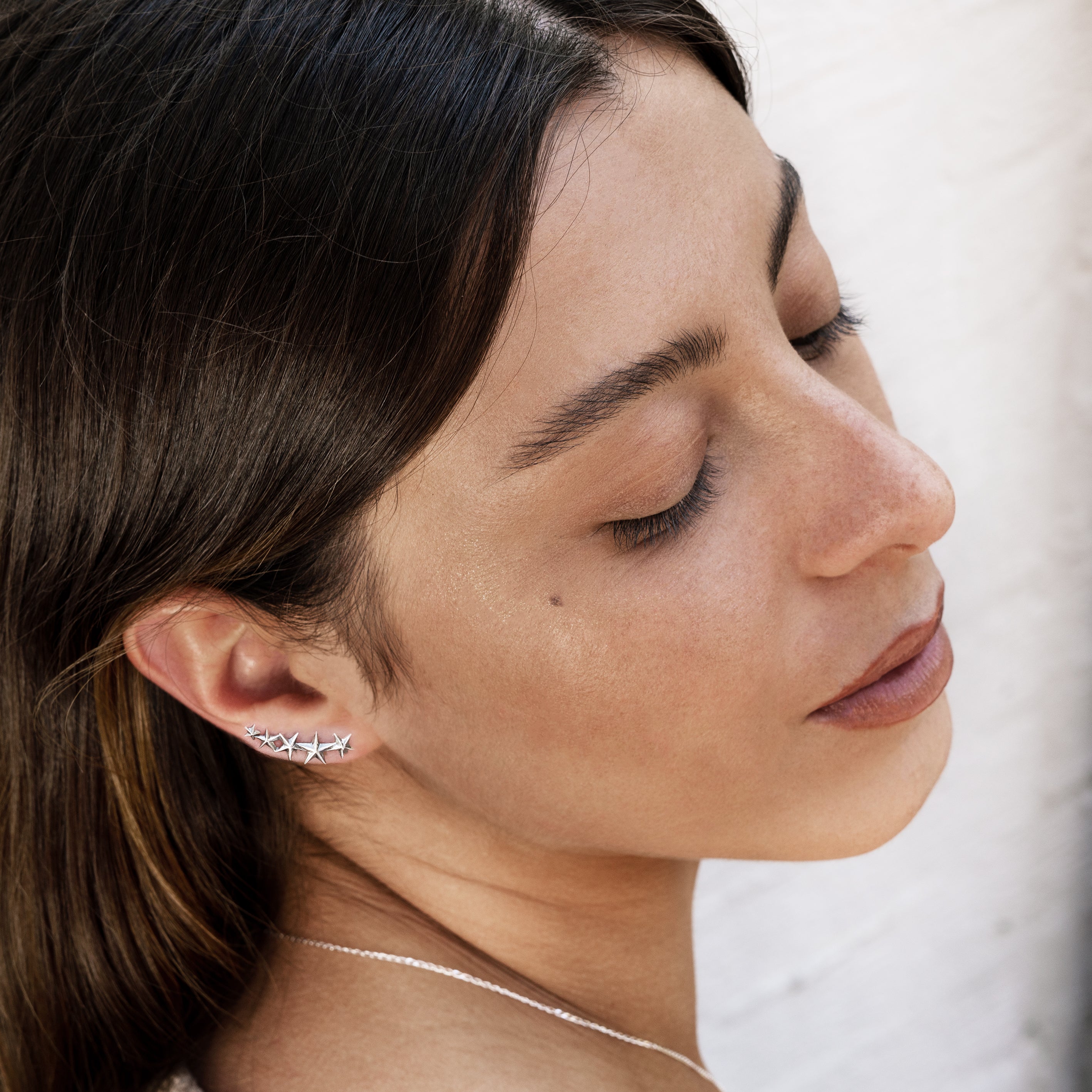 model wearing sterling silver stars ear climbers