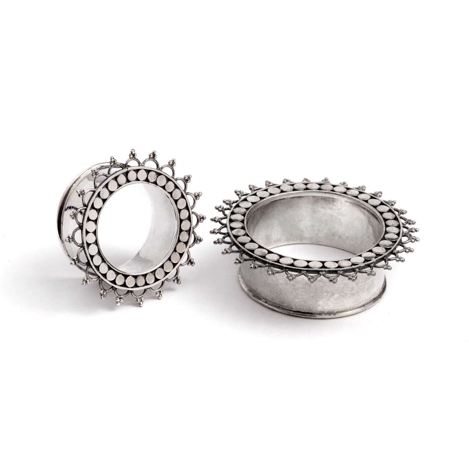 two sizes of silver tribal flower ear tunnels side and front left view