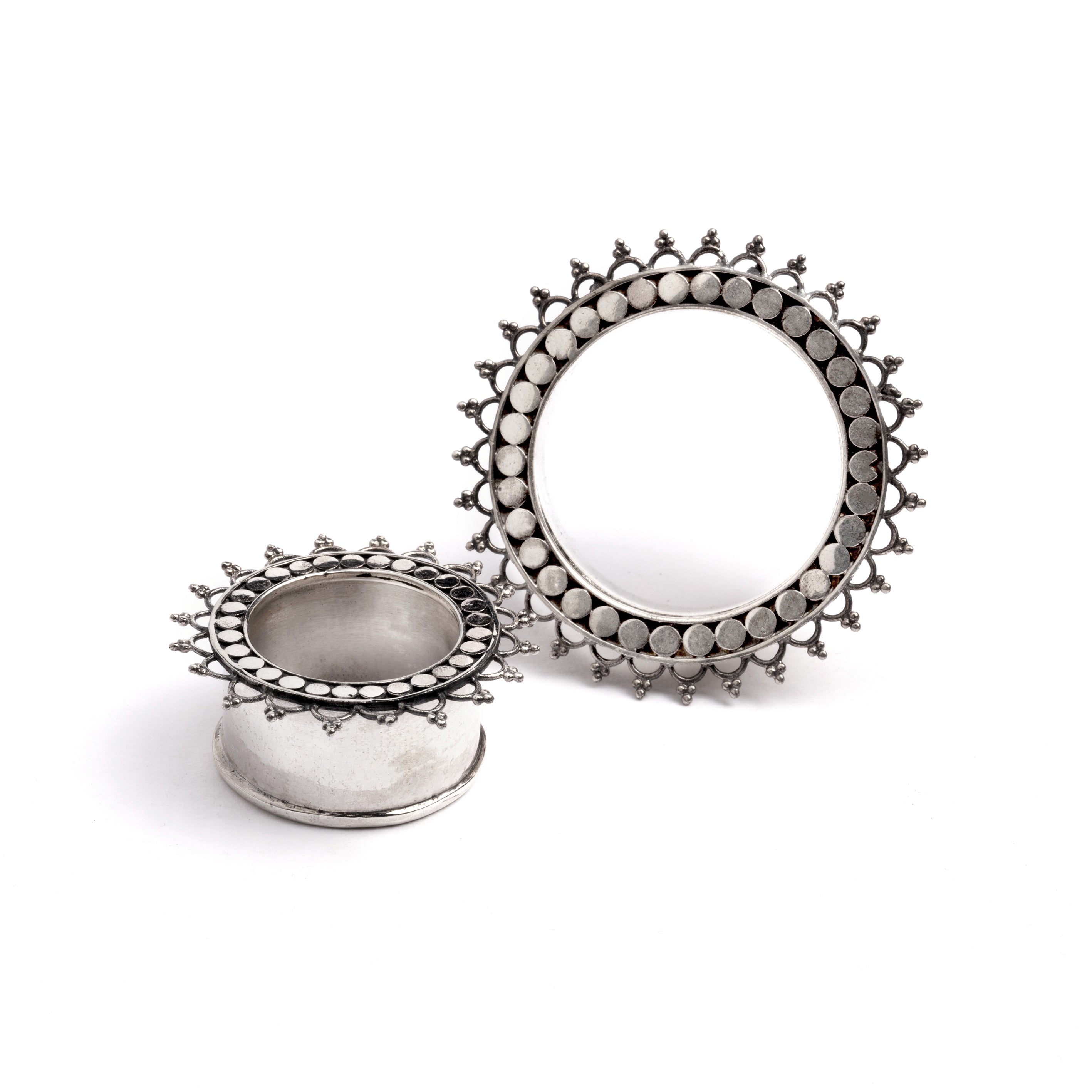 two sizes of silver tribal flower ear tunnels side and front view
