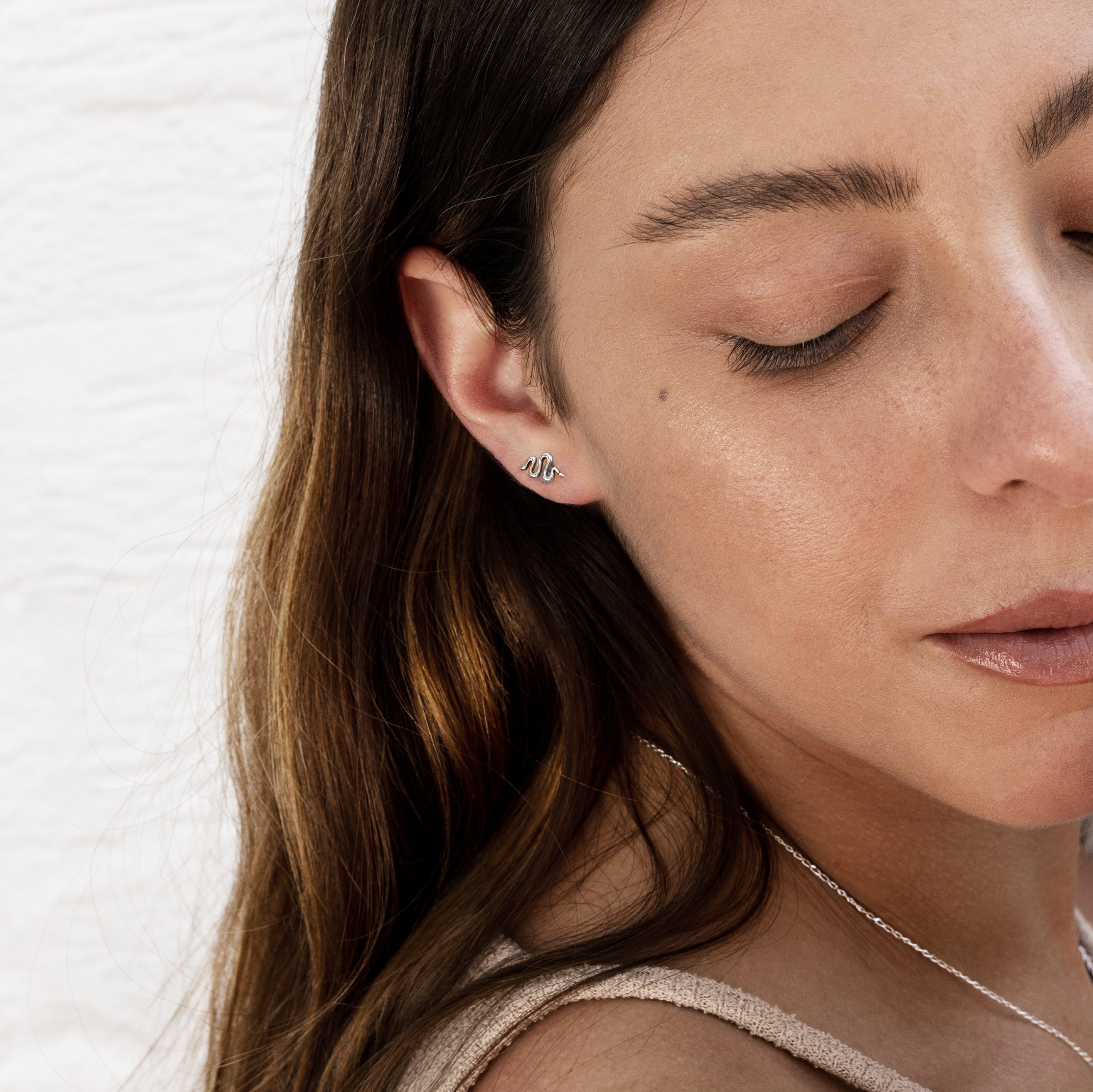 model wearing Snake silver stud earrings