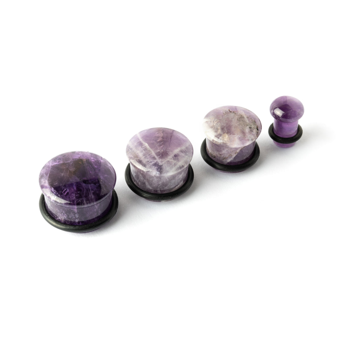 several sizes of Single Flare Amethyst stone ear plugs front view
