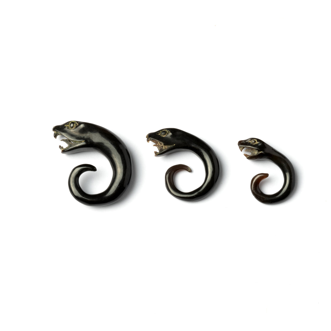 SEVERAL SIZES OF HORN CARVED SNAKE HEAD EAR STRETCHERS SIDE VIEW