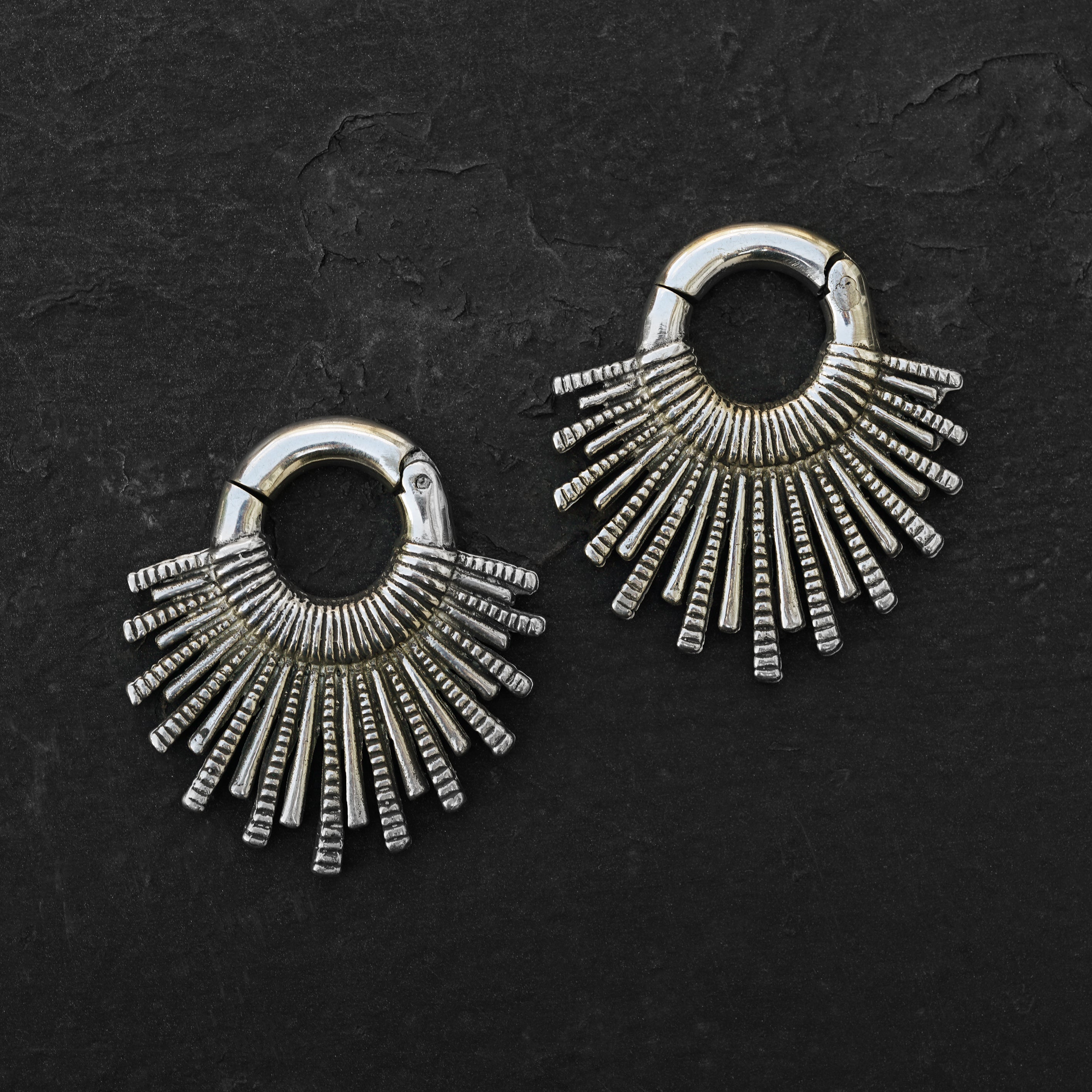 pair of silver brass tribal sun hoops hangers frontal view black background