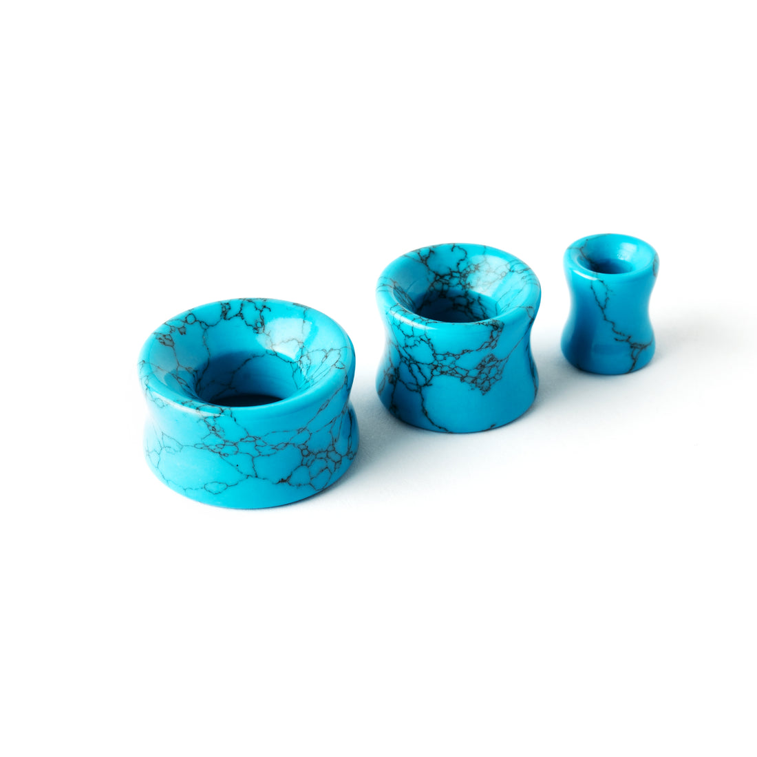 several sizes of turquoise double flare stone ear tunnels side view