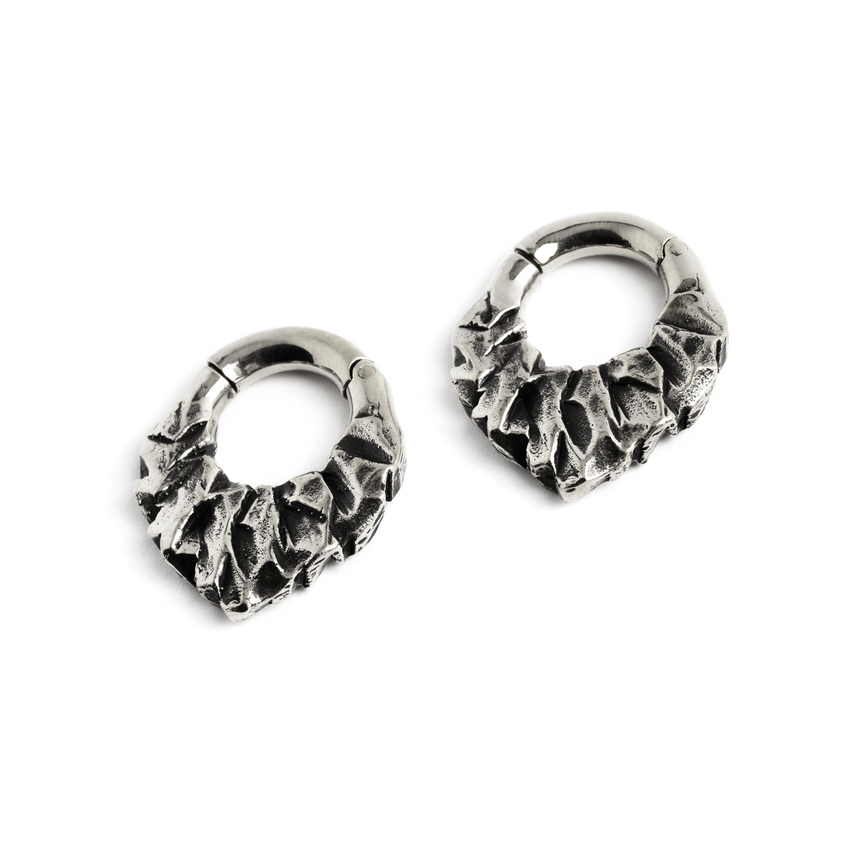pair of silver brass teardrop shaped ear hoops hangers with rocky texture left front view