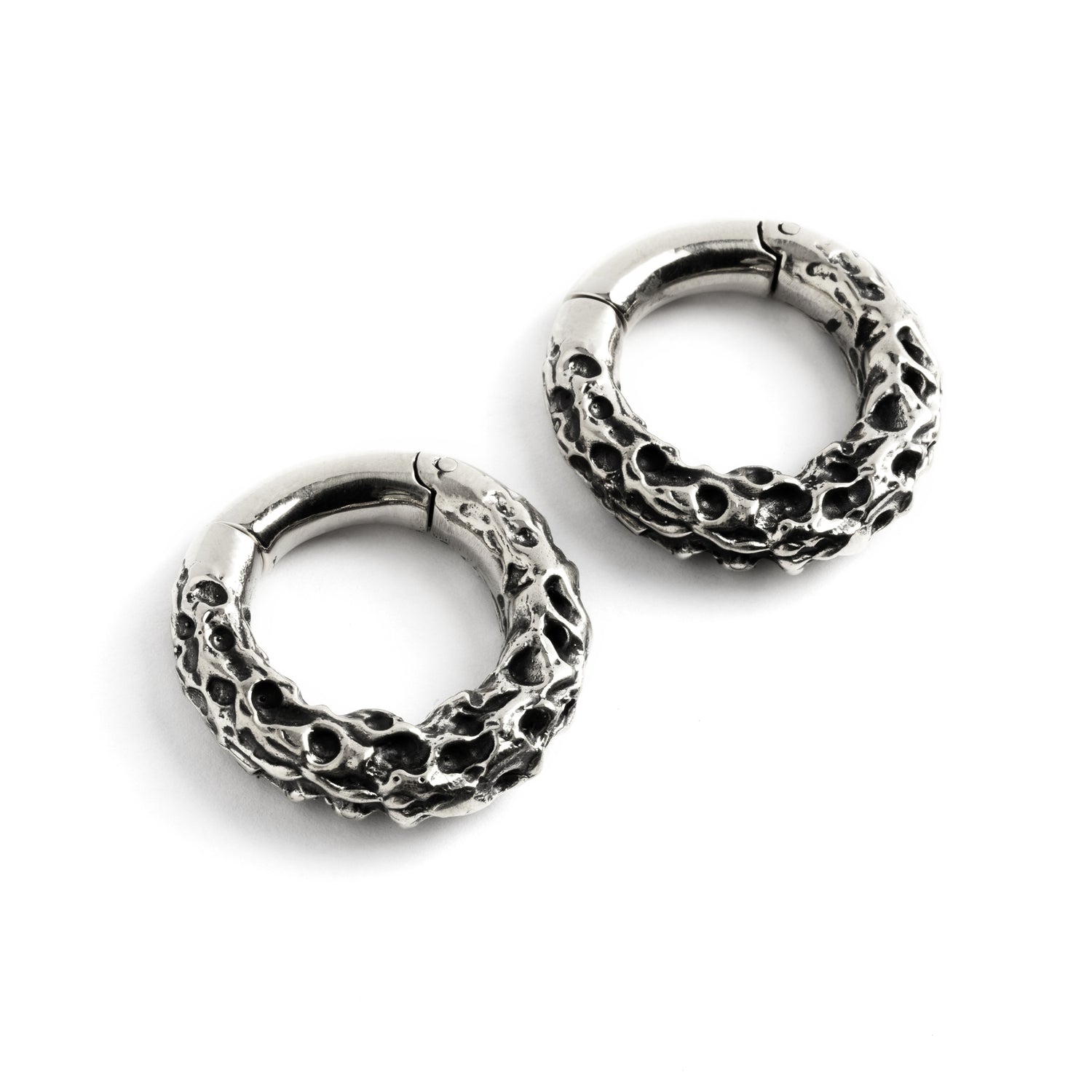 Pair of silver brass hoop hangers with rocky texture left front view