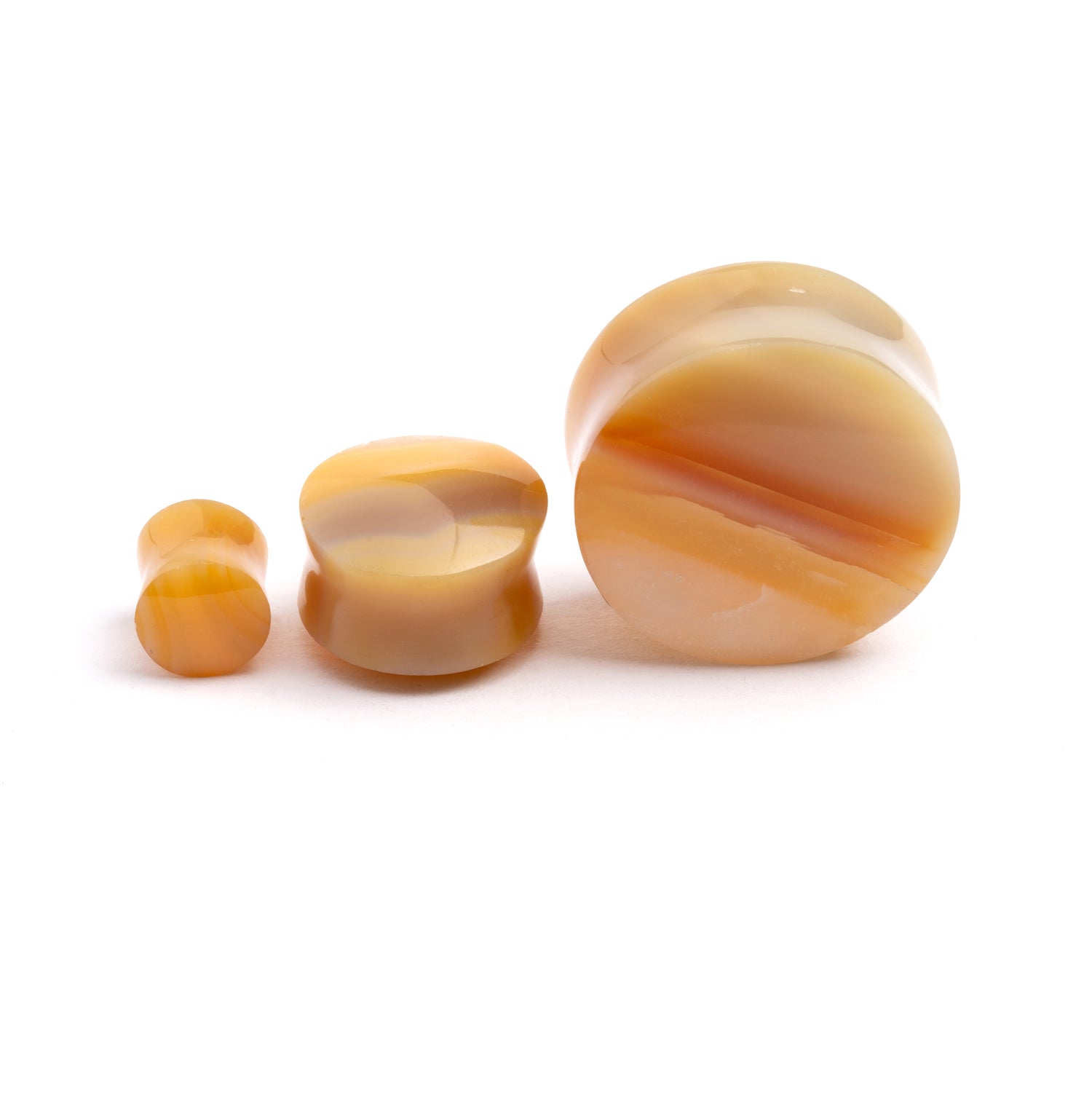 several sizes of Yellow Agate double flare stone ear plugs front and side view