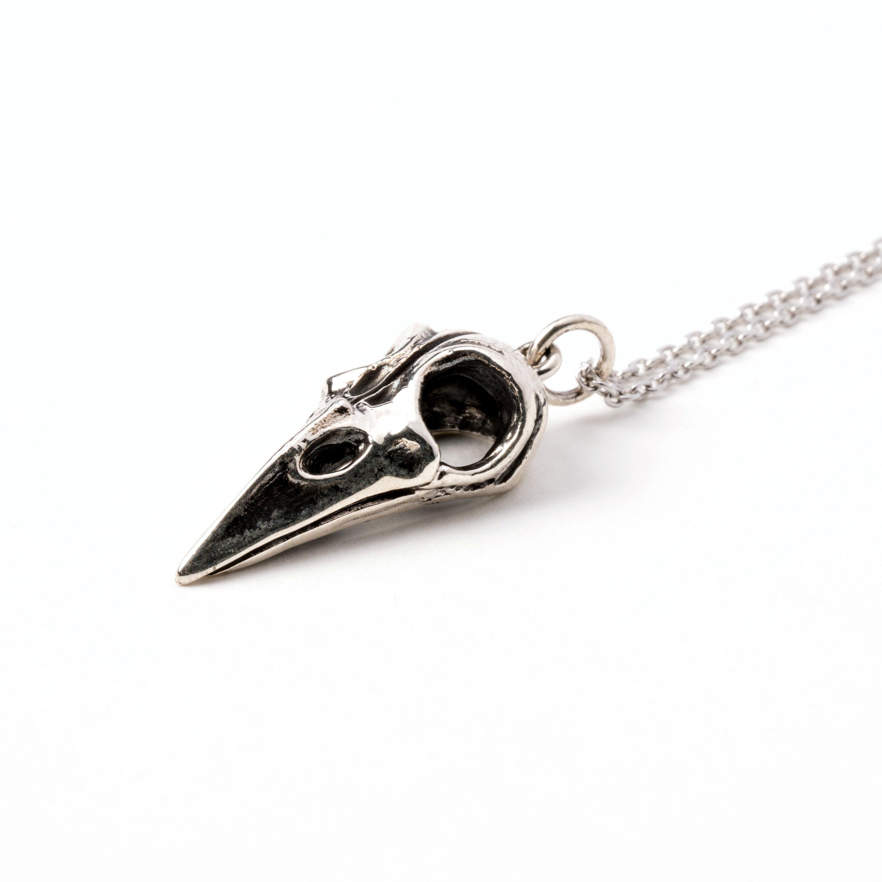 Silver raven skull necklace right side view