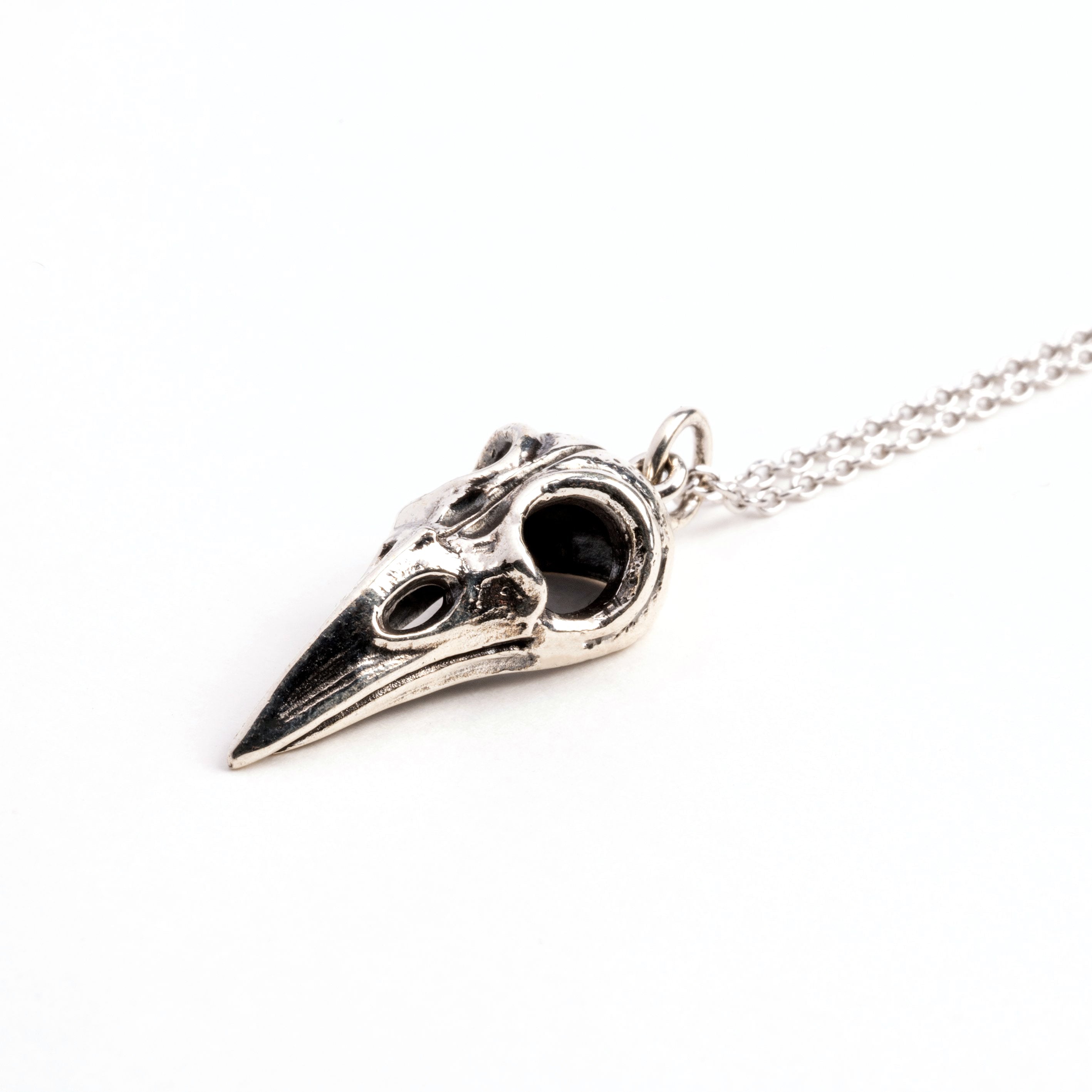 Silver raven skull necklace right side view