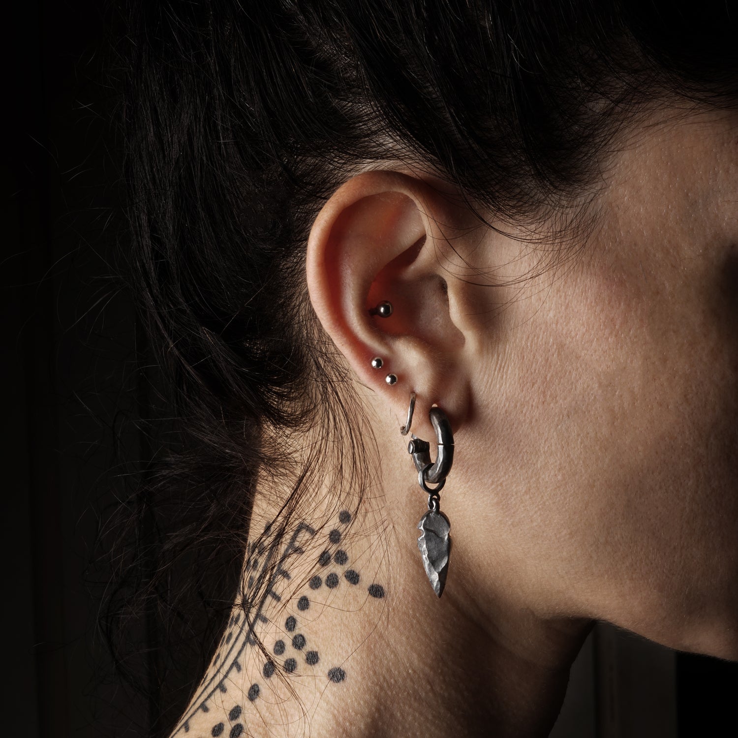 model wearing Black Silver Arrowhead Hangers