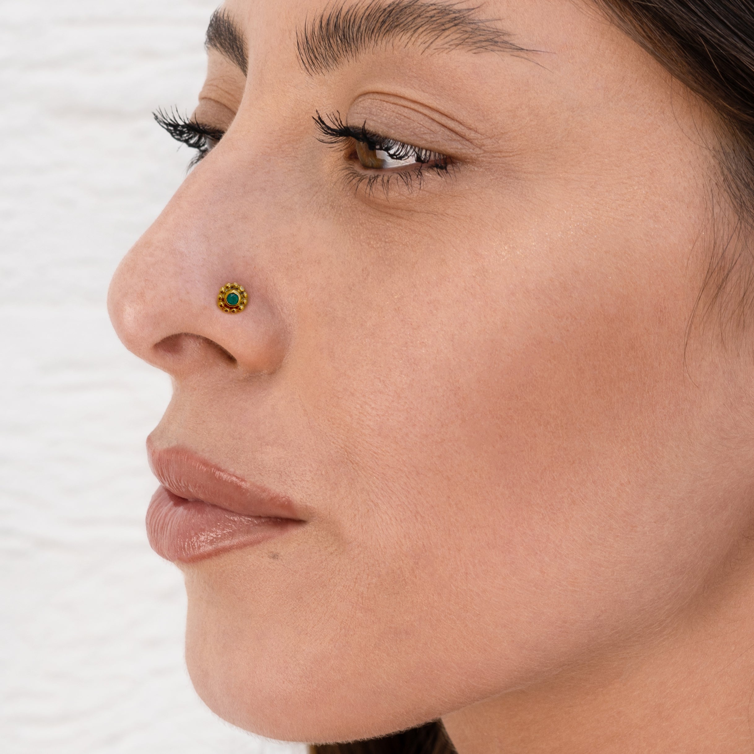 model wearing Gold Flower Nose Stud with black Spinel 