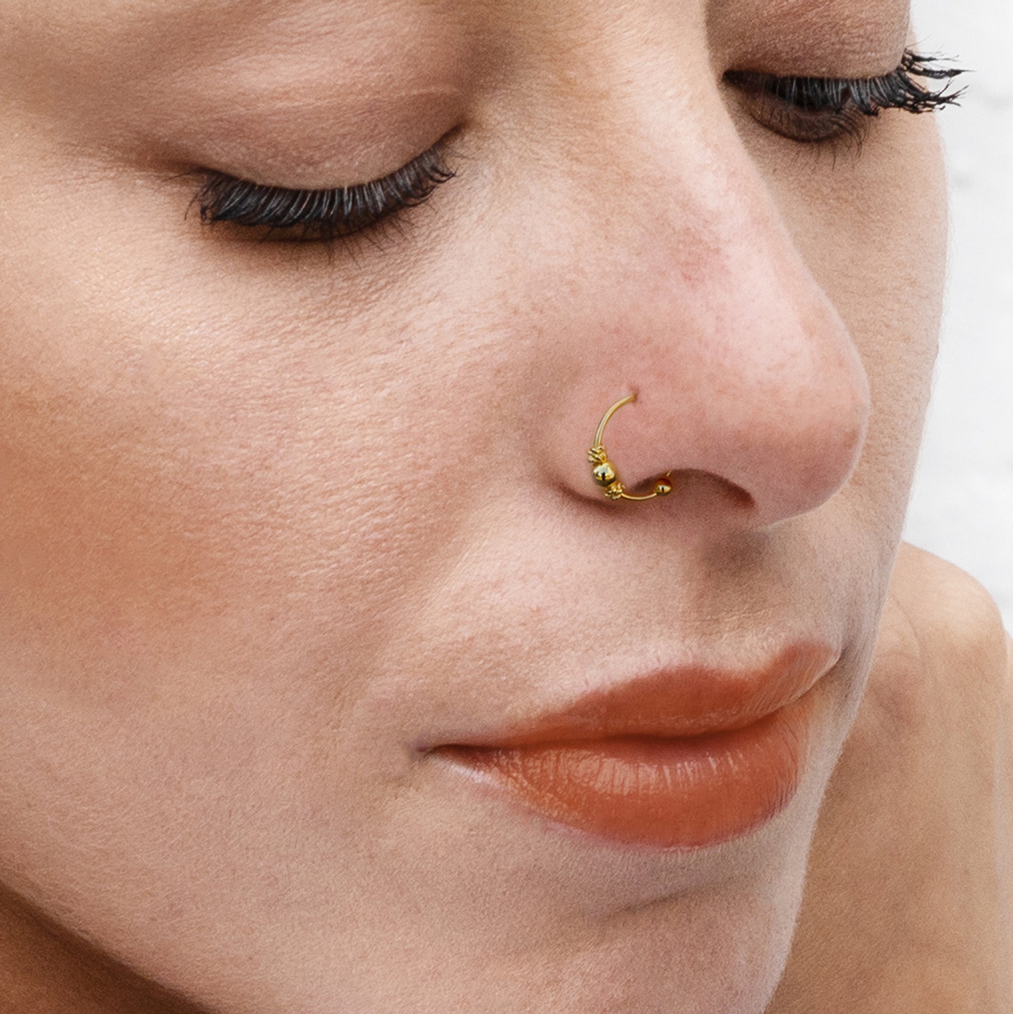 model wearing Gold Hera nose ring