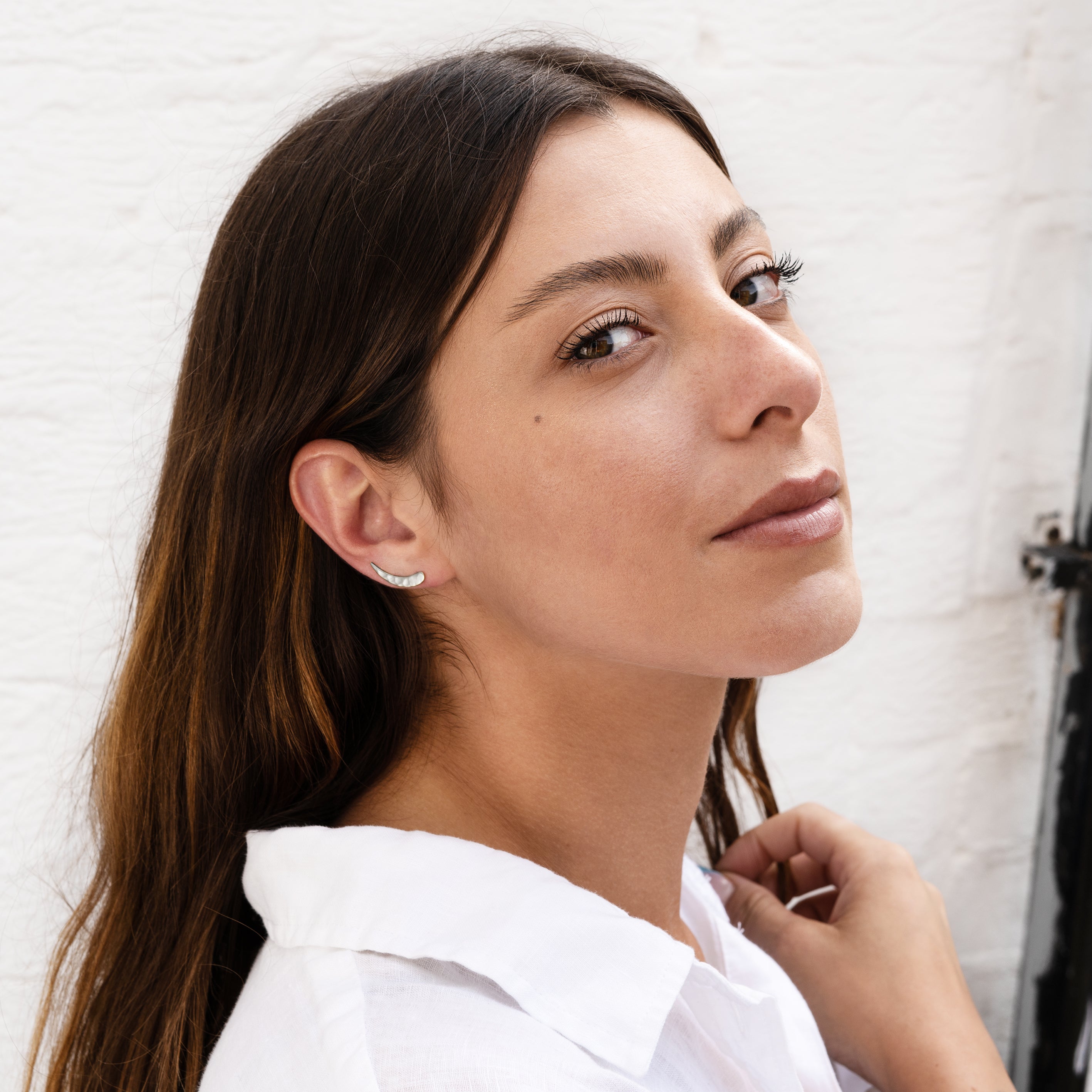 model wearing sterling silver hammered ear climber