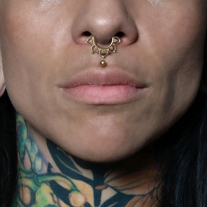 model wearing 14k Gold Lotus Septum Clicker