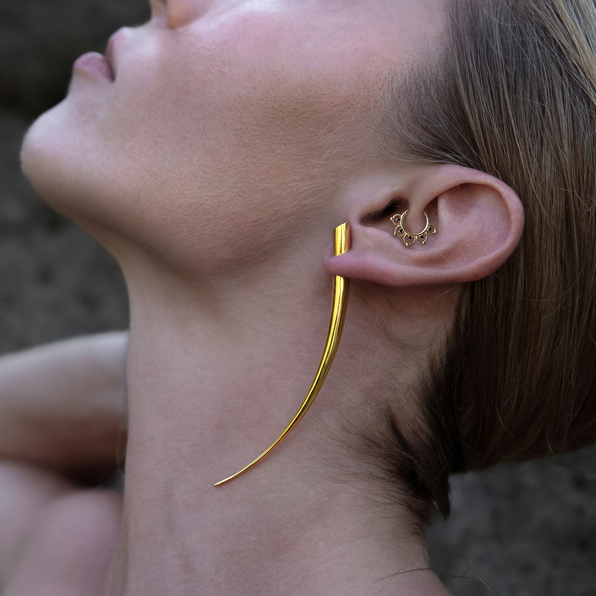 model wearing 14k Gold Open Lotus  Clicker ring on her daith