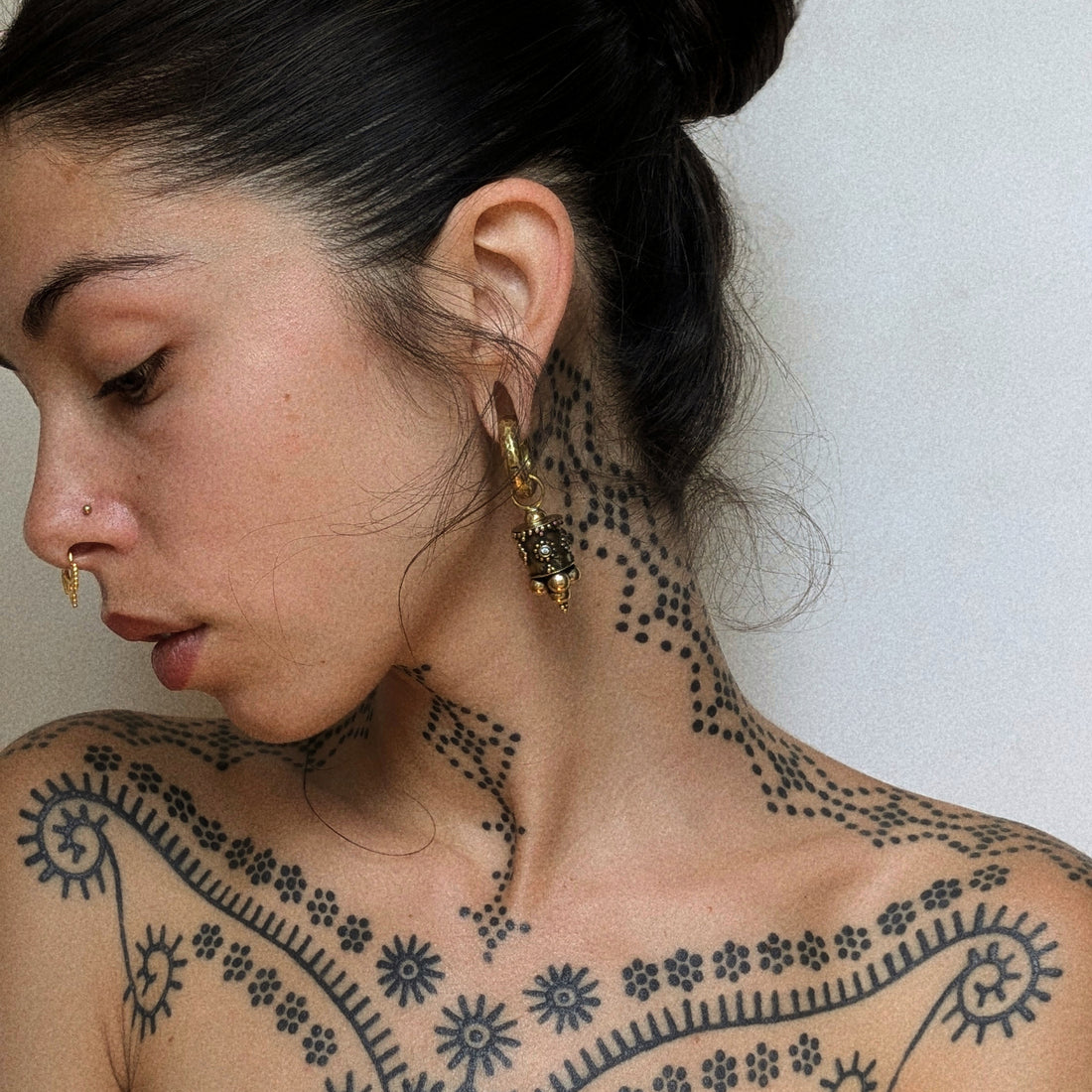 model wearing Afghan Ear Weights with Topaz