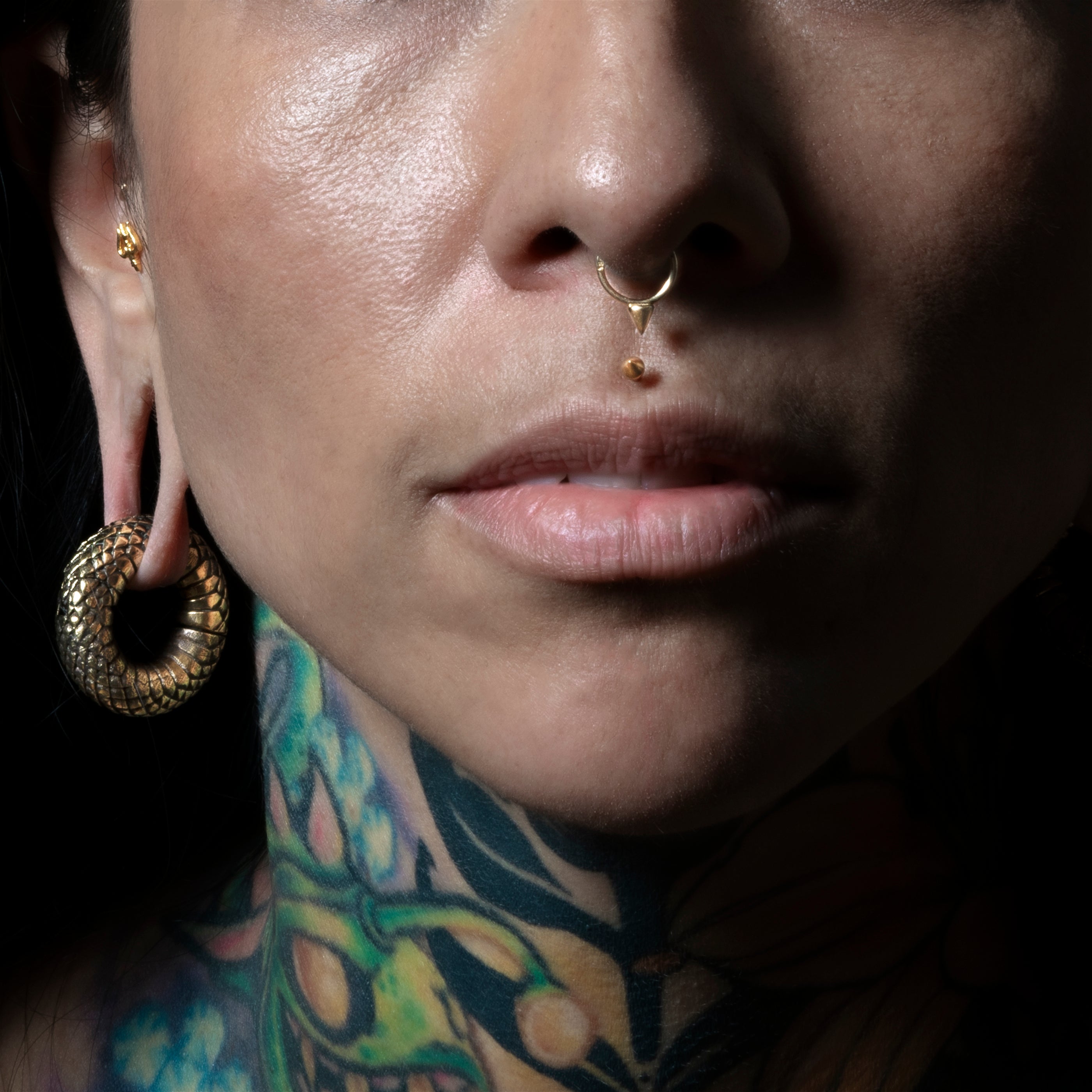 model wearing Golden Spike Labret and 14k gold spike clicker ring