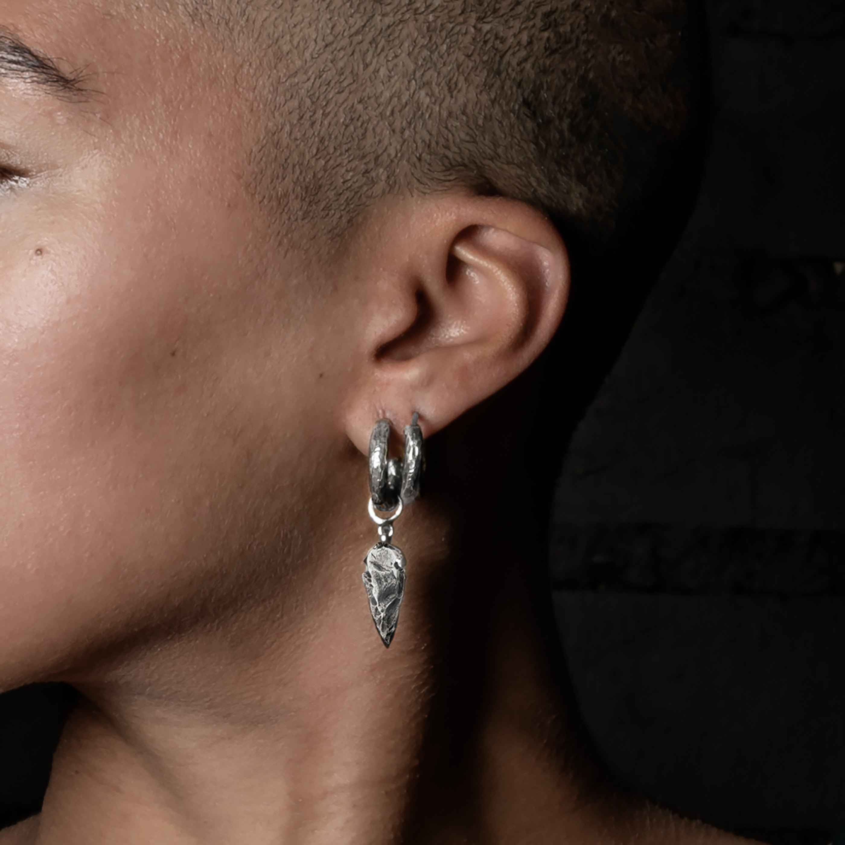model wearing Arrowhead Silver Clicker Earrings