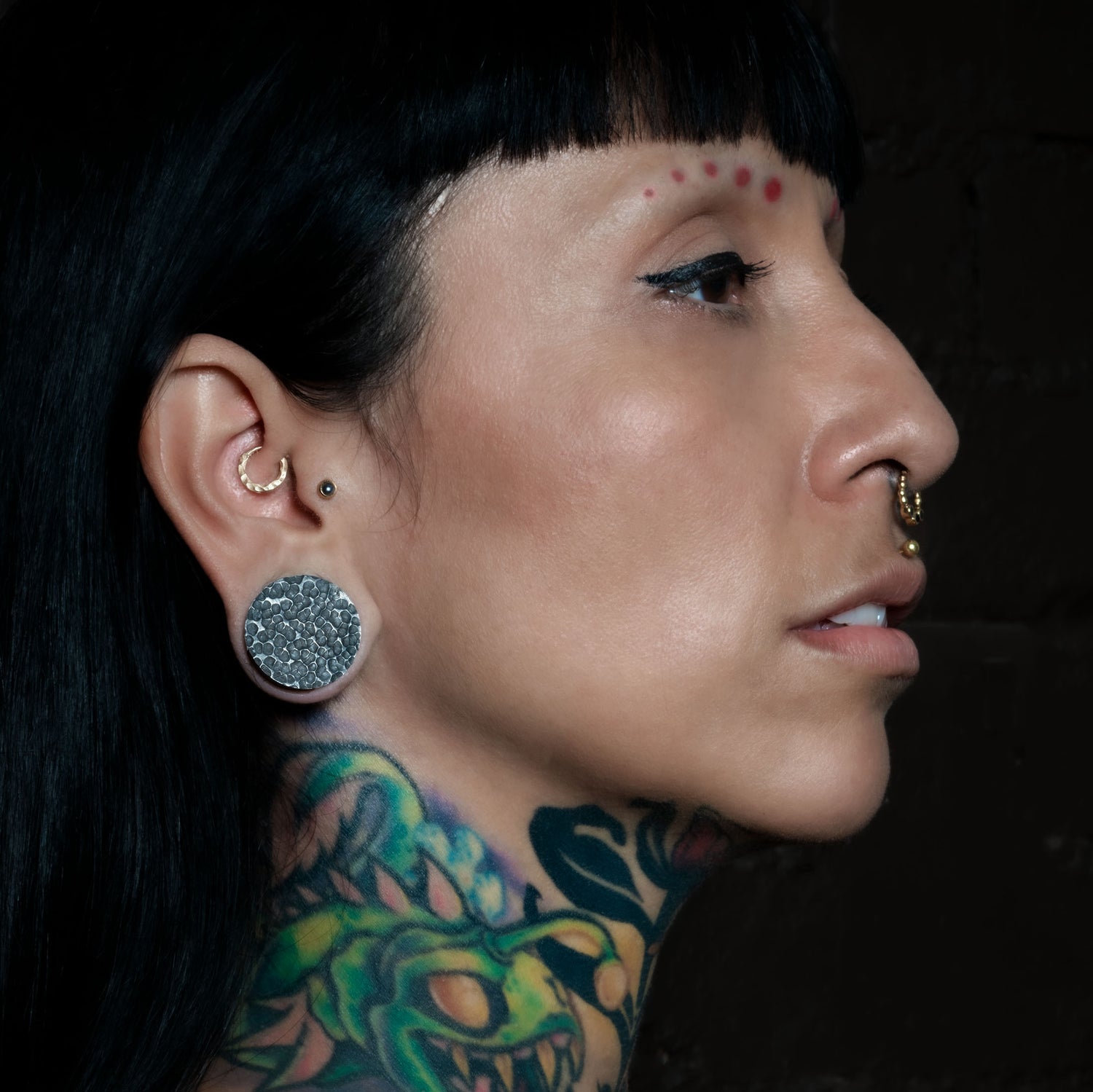 model wearing hammered black silver double flared ear plug