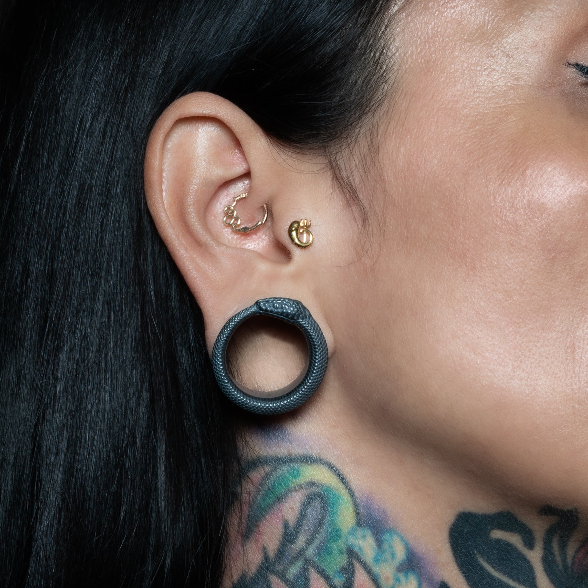 model wearing Black Silver Ouroboros Tunnels 