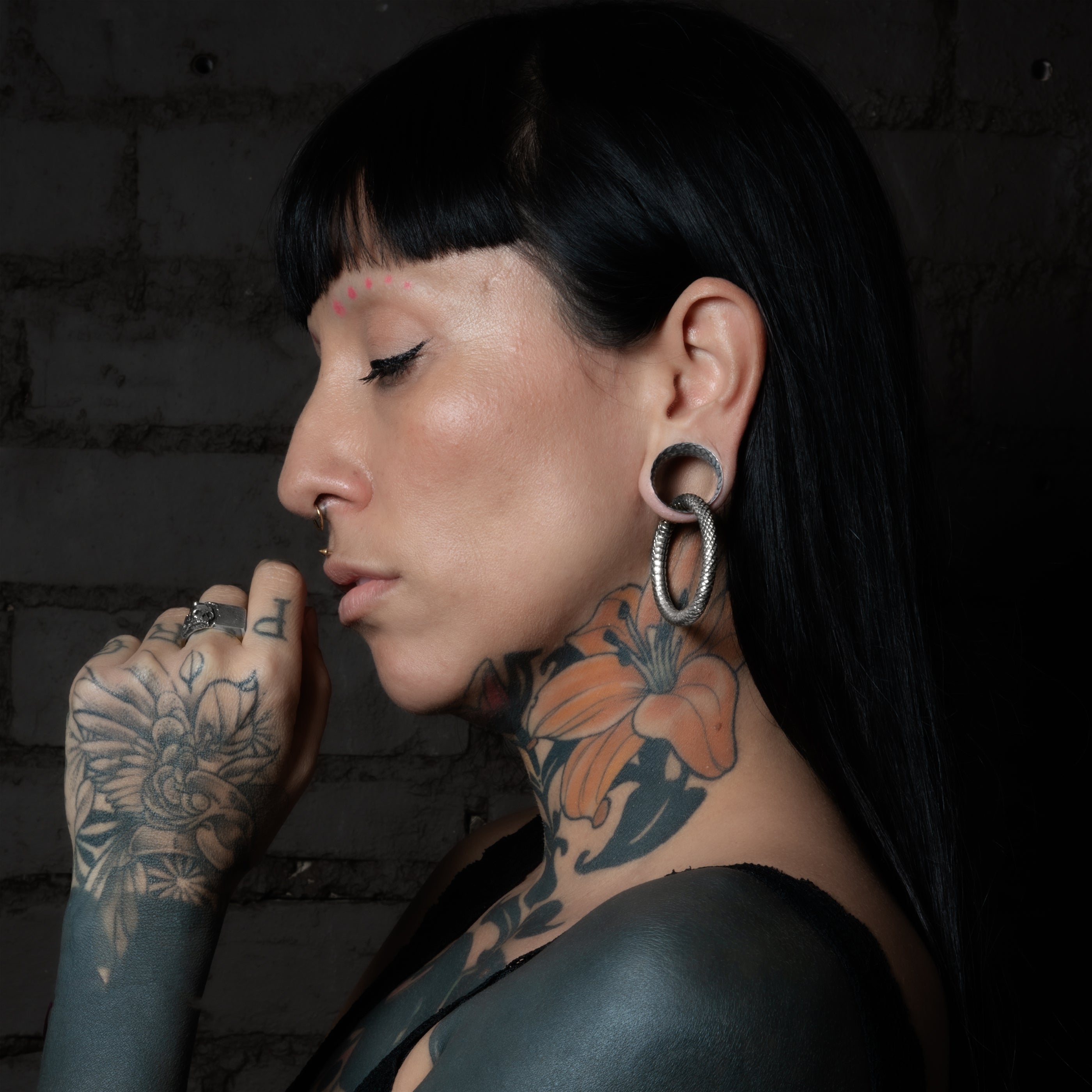 model wearing Hammered Silver Tunnels with rebirh hoops