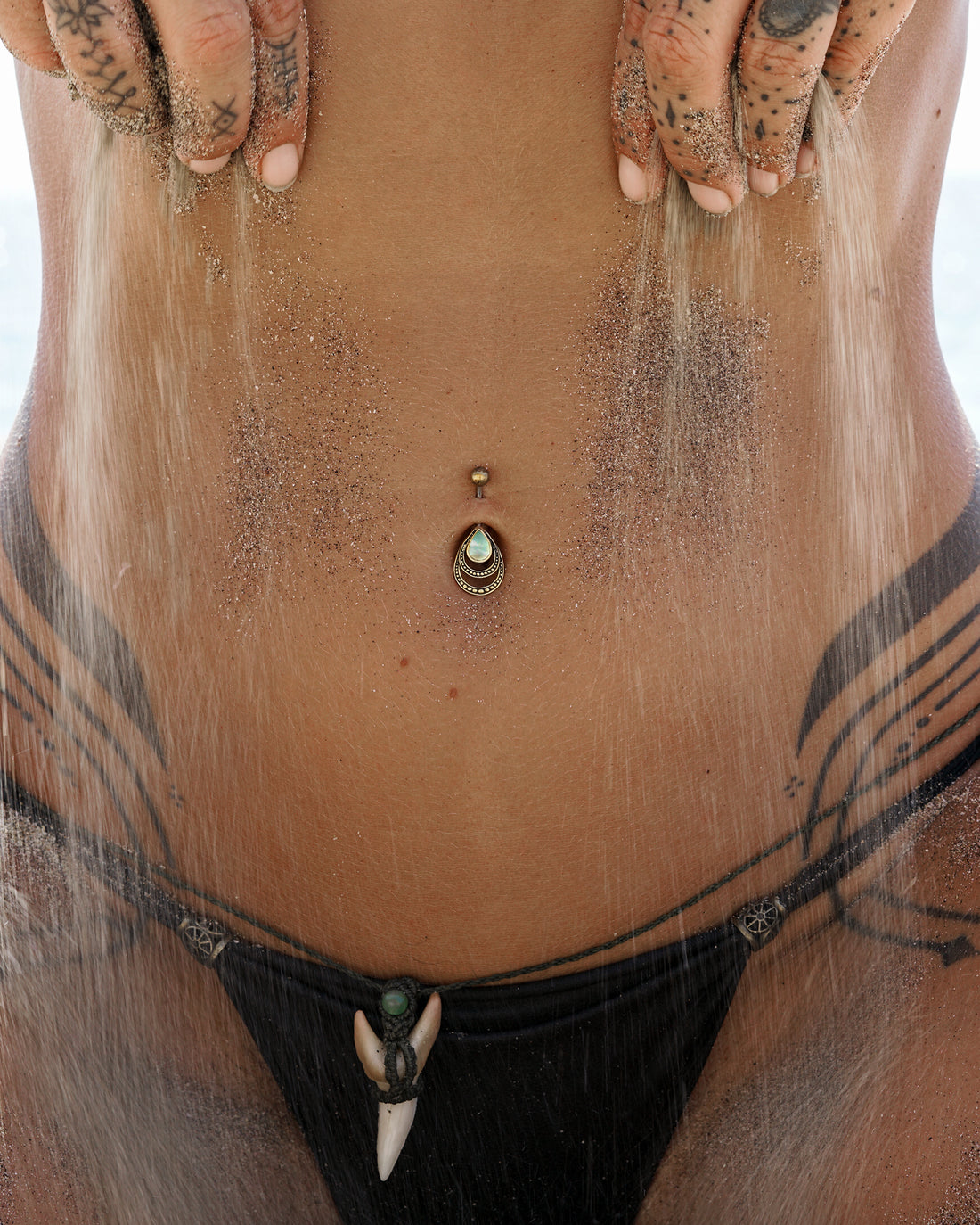 model wearing Drop Mother of Pearl Belly Bar