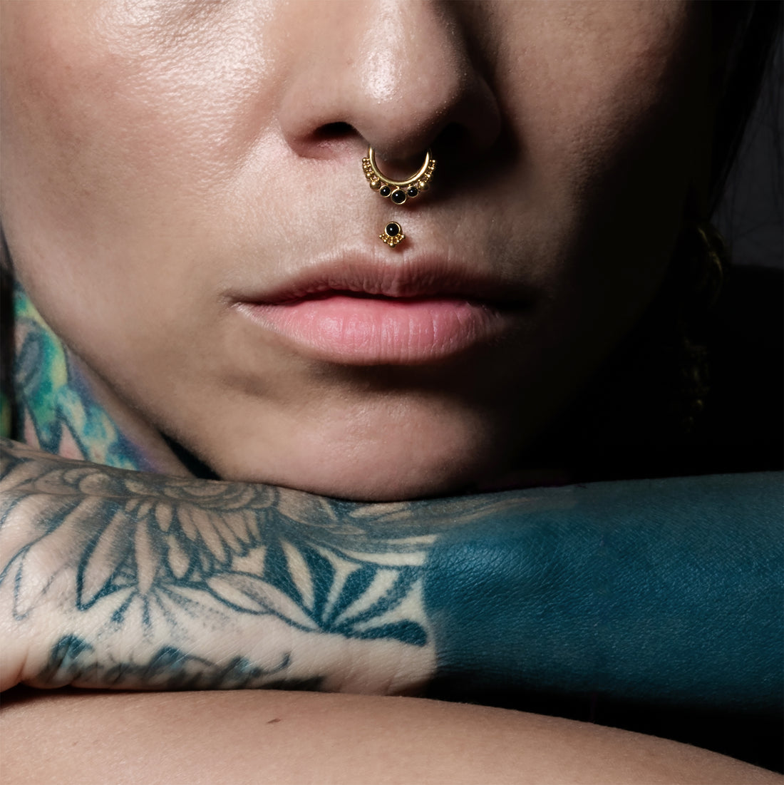 model wearing Golden Siti Clicker Ring with Black Onyx and Layla medusa labret