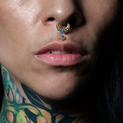 model wearing Layla Golden medusa Labret with Blue Opal and siti clicker septum